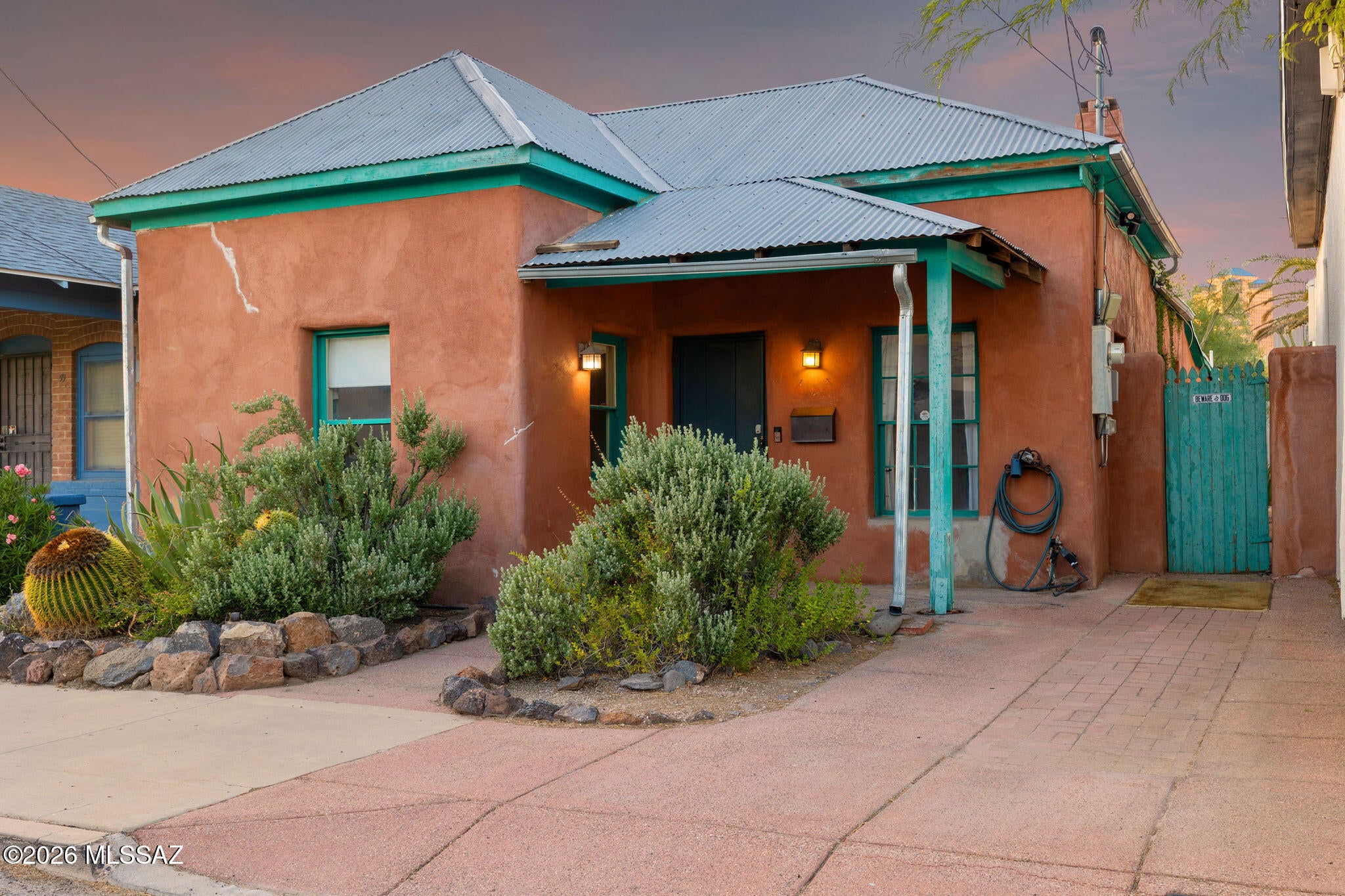 Step into the charm of historic Downtown Tucson with this unique 1900 adobe home, full of character and timeless Southwestern style. Featuring soaring ceilings, Saltillo tile floors, a cozy fireplace, colorful original details, and a private courtyard, this home blends historic charm with everyday comfort. The spacious backyard offers room to relax or entertain beneath mature desert landscaping. Located just minutes from Downtown Tucson, the University of Arizona, restaurants, shopping, and entertainment, this is a rare opportunity to own a piece of Tucson history in one of the city's most desirable urban neighborhoods.