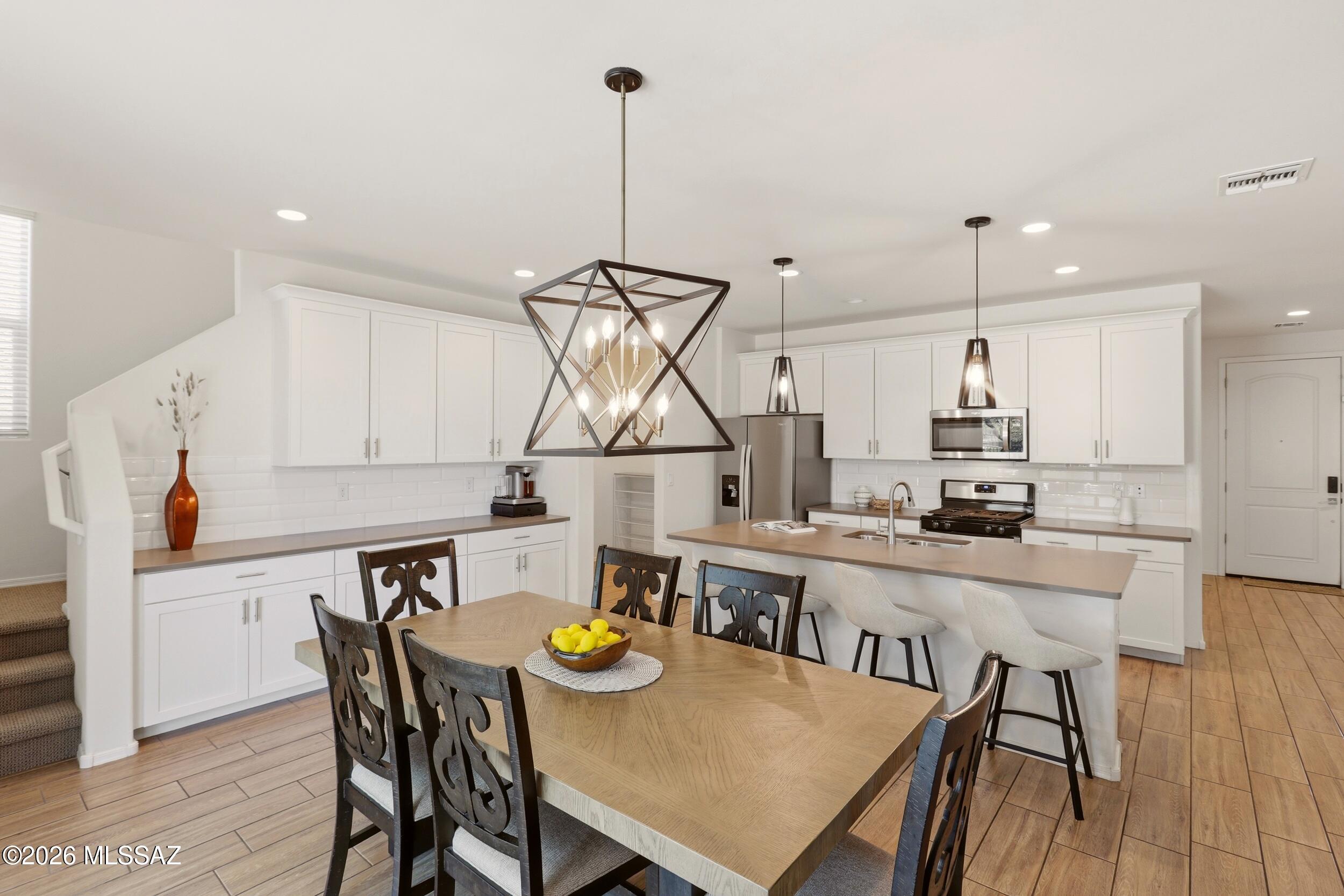Energy-efficient and move-in ready! This beautiful 2,575 SqFt Sandstone model in Gladden Farms offers 4 bedrooms, 3 baths, plus a versatile office/den. The open floor plan with 9' ceilings creates a bright, spacious feel perfect for everyday living and entertaining. The kitchen features 42'' Maple Linen cabinets, quartz countertops, white subway tile backsplash, and wood-look tile flooring. The primary suite offers dual sinks, a walk-in shower, and large walk-in closet. Enjoy a professionally landscaped backyard with a covered patio, mature trees, and sunset views. Close to top-rated schools, parks,  splash pad, grocery store, future aquatic center, and easy I-10 access.