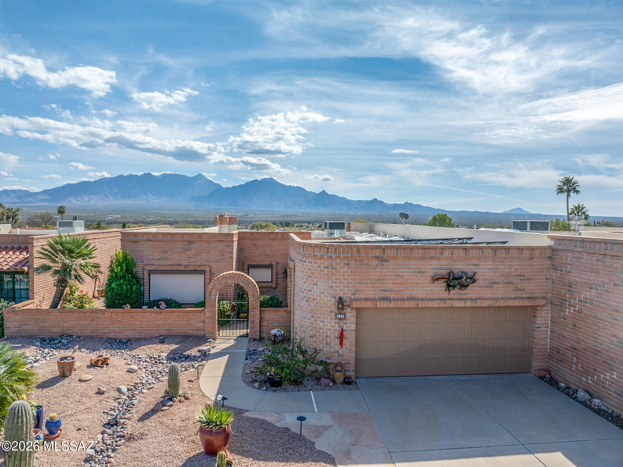 WALK INTO YOUR NEW HOME AND BE CAPTIVATED BY PANORAMIC VIEWS OF ELEPHANT HEAD AND THE SANTA RITA MOUNTAINS. This impeccably upgraded residence exudes refined luxury with tile and wood flooring throughout, custom granite surfaces, and bespoke cabinetry in both baths. A designer kitchen remodel completed in 2025 anchors the home with elevated style and functionality. Open floorplan w/a beehive fireplace, mountain views form inside & upgraded shutters. Thoughtful enhancements include owned solar installed in 2022, upgraded heating and cooling in November 2023, and a new gas water heater 2019. Resort-style outdoor living features a solar-heated pool with cover and a private putting and chipping green. An oversize two-car garage with dedicated work space completes this exceptional offering.