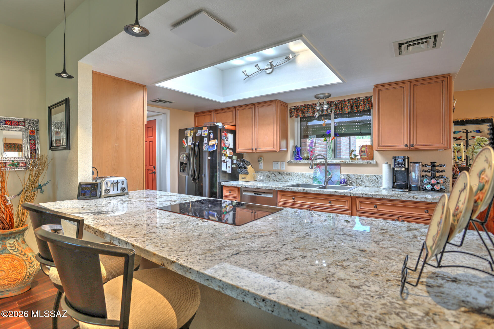 WALK INTO YOUR NEW HOME AND BE CAPTIVATED BY PANORAMIC VIEWS OF ELEPHANT HEAD AND THE SANTA RITA MOUNTAINS. This impeccably upgraded residence exudes refined luxury with tile and wood flooring throughout, custom granite surfaces, and bespoke cabinetry in both baths. A designer kitchen remodel completed in 2025 anchors the home with elevated style and functionality. Open floorplan w/a beehive fireplace, mountain views form inside & upgraded shutters. Thoughtful enhancements include owned solar installed in 2022, upgraded heating and cooling in November 2023, and a new gas water heater 2019. Resort-style outdoor living features a solar-heated pool with cover and a private putting and chipping green. An oversize two-car garage with dedicated work space completes this exceptional offering.