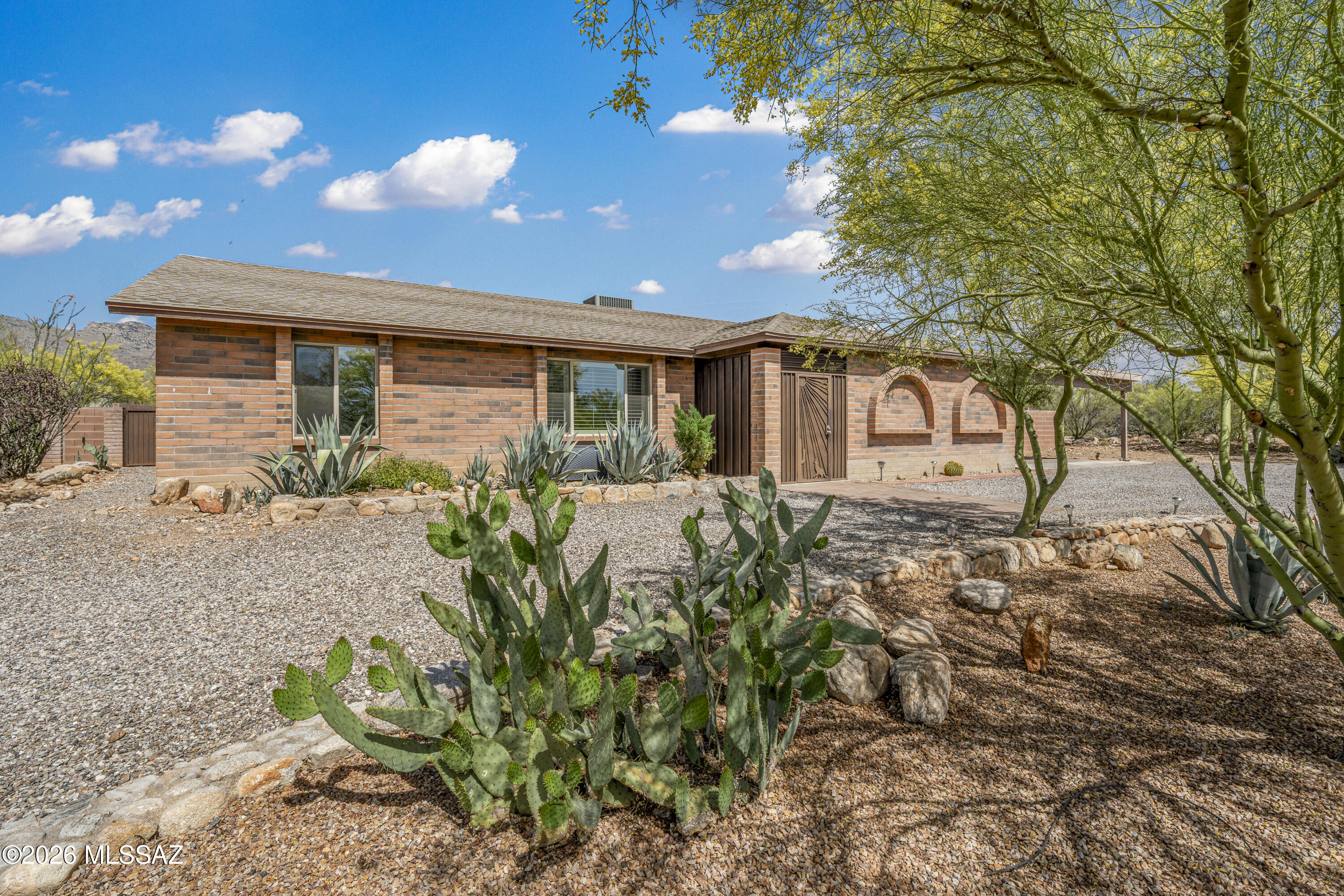 Fantastic foothills retreat with impressive mountain views, modern finishes and dual primary suites! Inside you'll find high ceilings, beautiful ceramic tile in all the right places, a generous greatroom and dining area ideal for everyday living or entertaining.    Kitchen shines with granite counters, stainless steel appliances, large island with seating & RO at the sink.  Both primary suites offer walk-in showers and walk-in closets. 3rd bedroom features a lovely bay window.  4th bedroom has a beautiful Murphy bed & desk.   Step outside to a huge block walled in backyard with views, covered patio and endless potential.  Whole-house water filtration system.    Ideally located in the foothills close to top shopping & dining & a short drive to U of A & vibrant Downtown Tucson.