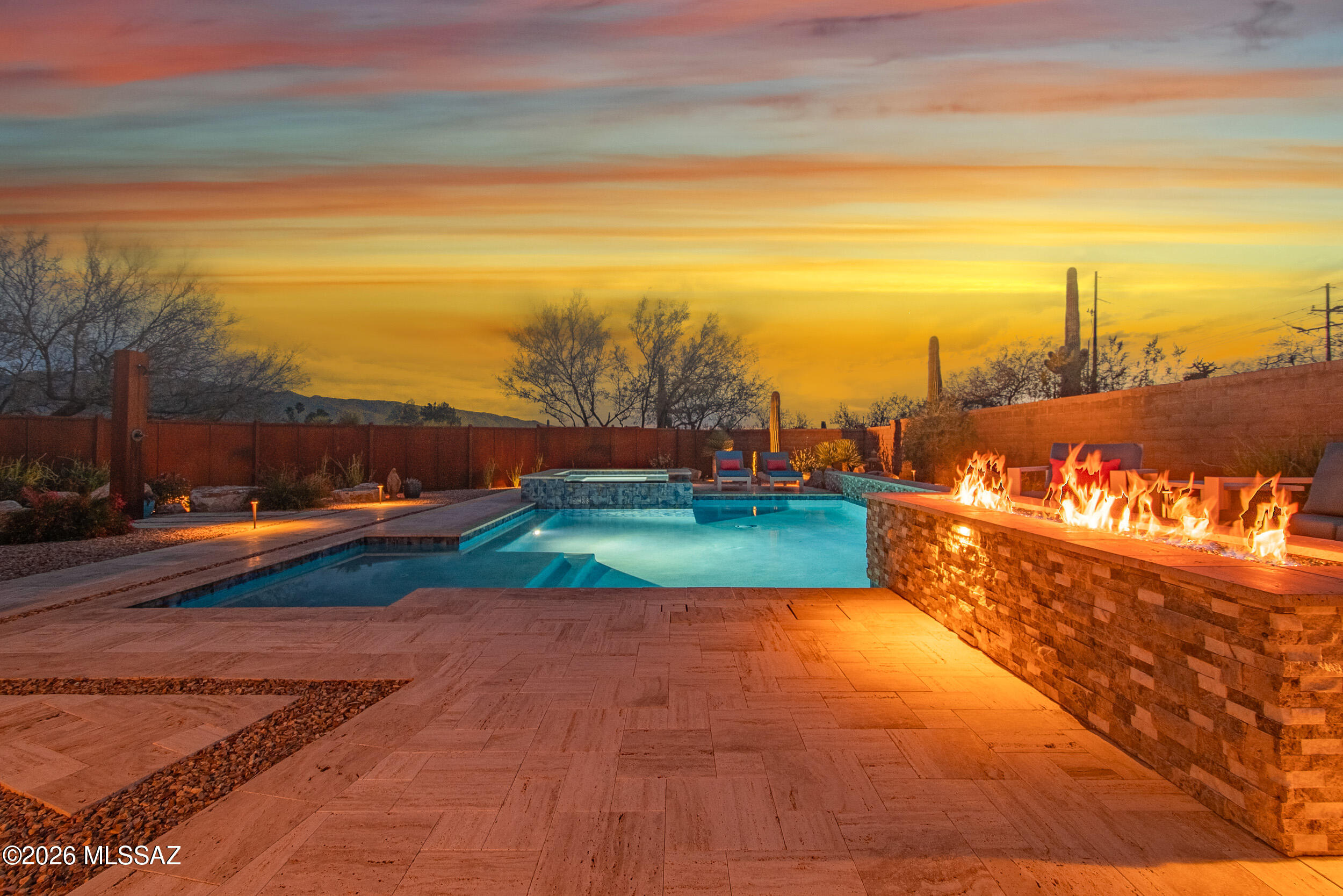 Award-winning design and resort-style outdoor living in the private, gated enclave of Soldier Trail Estates - a community of just six homes. This 2022 ASID Design Excellence Award winner was curated top to bottom by renowned designer Adria Somerville of Mood Design Phoenix: custom millwork including a curved living-room bookshelf built to match the architecture, designer finishes and a cohesive color palette throughout, soaring 9+ foot ceilings, and solar tubes that fill the home with natural light. Dual-pane windows frame the Catalinas, Rincons, Agua Caliente Hill, and Santa Ritas from nearly every room.
Outside, a custom-designed pool and spa with an overflow water feature, a natural-gas fire feature with travertine and stacked-stone surrounds, hand-set boulders... ...full landscape lighting, and a built-in outdoor kitchen with slate countertop -- all set within low-maintenance xeriscape and drip irrigation front and back.

Systems have been updated for peace of mind: both HVAC units replaced in 2024, a new elastomeric roof coating in 2026, a new 50-gallon water heater in 2026, and a newer dishwasher and washer. Move-in ready and offered by the original owners; nearly all furnishings are negotiable. Ask for the full Custom Upgrades & Features list found in the attached documents.