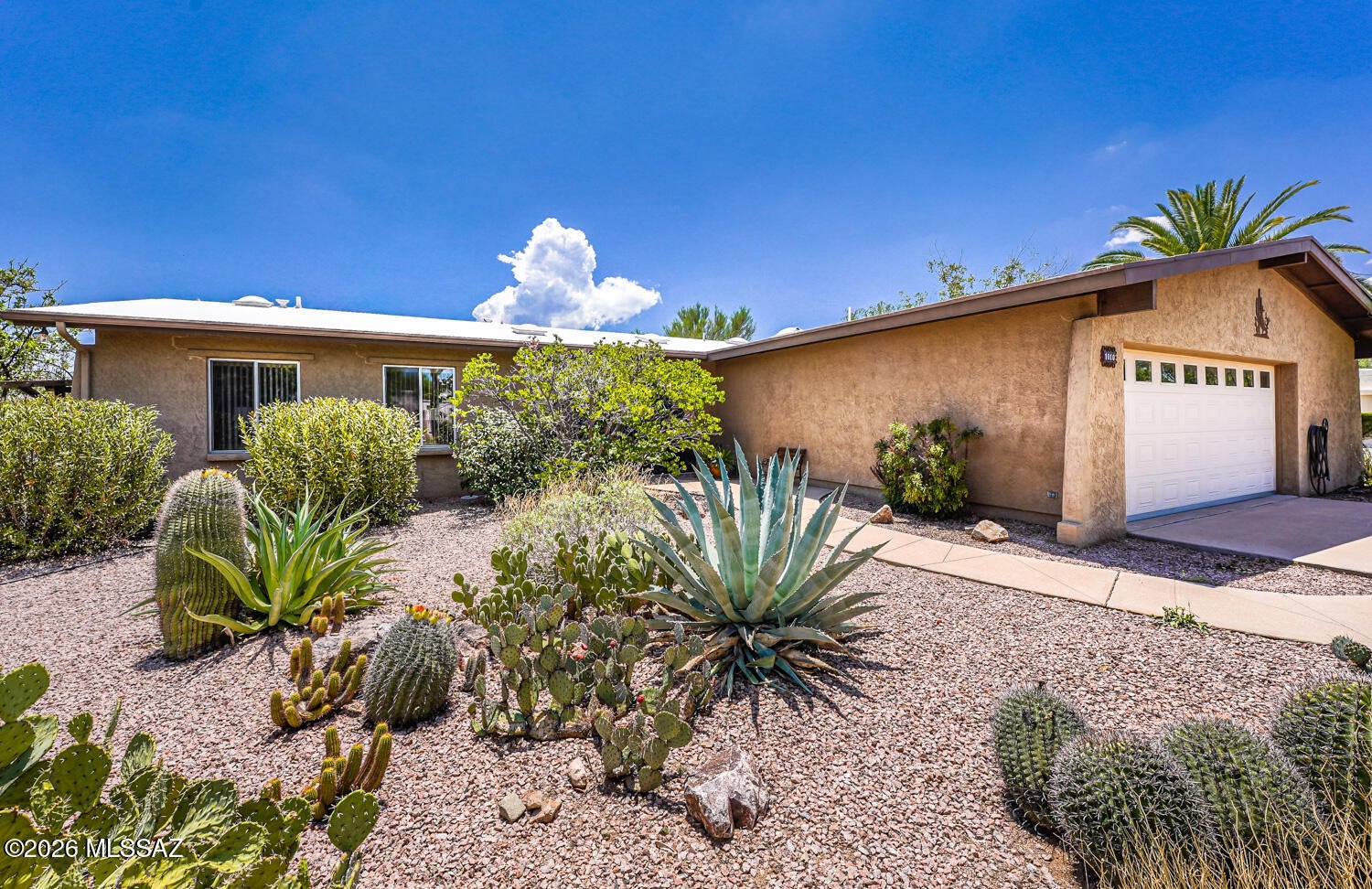 Privacy, Views & Arizona Living at Its Best! Tucked away on nearly a half-acre cul-de-sac lot, this custom-built 3-bedroom, 2-bath home, with mountain views offers the perfect combination of privacy, comfort, and Arizona charm. Designed for comfortable everyday life, the inviting living room serves as the heart of the home, featuring a striking wood-burning fireplace with a beautiful slate surround that creates a warm and welcoming atmosphere. The modern remodeled kitchen with granite countertops, upgraded cabinetry, stainless steel appliances, a newer range, new faucet, new garbage disposal, and opens to a bright dining area. The primary suite is a relaxing retreat with a walk-in closet and an updated bathroom complete with a custom tiled walk-in shower. Two additional bedrooms provide endless possibilities for guests, a home office, or a hobby room. The guest bathroom has also been beautifully updated and features a stylish walk-in tiled shower.  Spend your afternoons in the Arizona room while enjoying mountain views and the peaceful beauty of the backyard. Step outside and discover one of this home's most inviting features, a peaceful backyard retreat surrounded by mature landscaping, abundant fruit trees, and beautiful mountain scenery. Whether you're bird watching, gardening, entertaining friends, or simply relaxing with your morning coffee, this tranquil outdoor space is the perfect place to enjoy Arizona living. Take advantage of the energy savings that the solar lease offers. LOW HOA only 35/year!. Additional features include: Updated light fixtures, Hot water recirculating pump, newer water softener, 2 car garage with heavy duty storage racks and separate workshop and storage room, Termite warranty, large laundry room with desirable utility sink with new faucet. Enjoy all the amenities that Green Valley recreation membership offers like pools, pickable courts, gyms, classes, clubs and much more. Great location just minutes away from shopping, restaurants and easy access to I-19. All around a fantastic home that you can not miss.