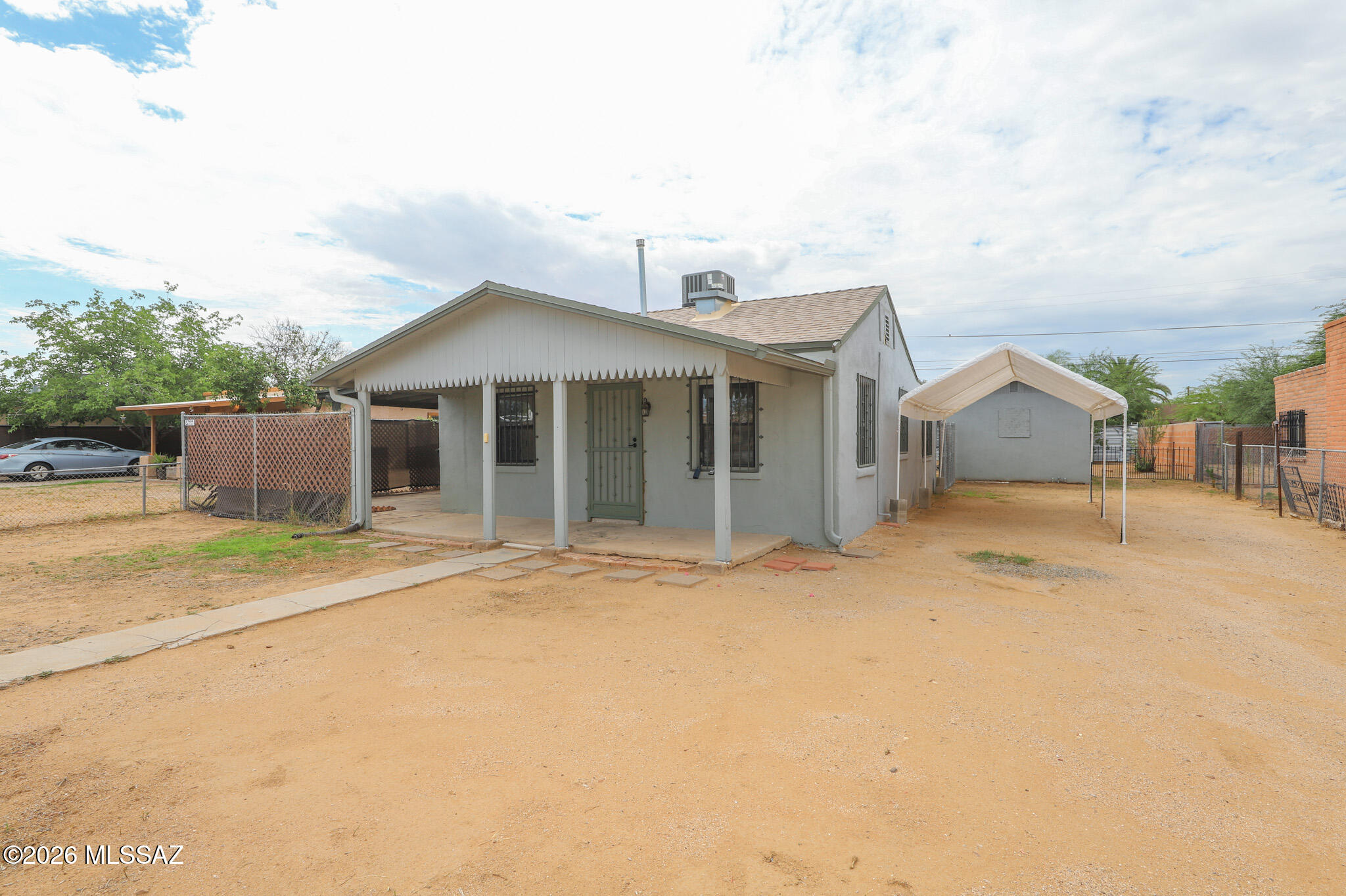 Spacious R-2 lot with a 720 sq ft move-in ready home and a separate workshop with electric & water. Large insulated tuff shed conveys as well as all the appliances & the trampoline! HVAC installed in 2018, large tuff shed & new roof installed in 2021, new gas pipes in 2022, new wrought iron installed on all doors & windows of the home, workshop & shed in 2023. Completely fenced with no HOA. Minutes to the freeway. Great opportunity with many possibilities!