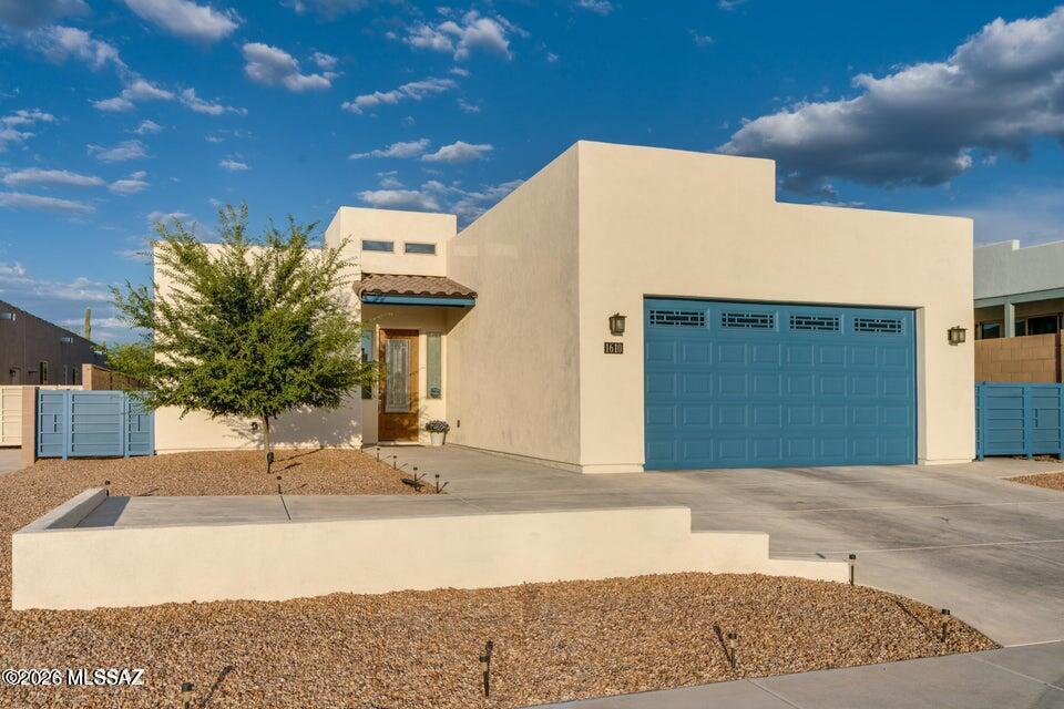 Modern desert living in this 4-bedroom, 3-bath home in a private 12-home community. Built in 2020, the open-concept floor plan features a chef's kitchen with a quartz island, microwave drawer, and seamless flow into the family room with a fireplace, formal dining with a custom wet bar with a wine cooler. French doors from the great room and primary suite open to an oversized covered patio with a gas grill valve and a landscaped backyard with desert plantings. The primary suite offers dual vanities and a walk-in closet. Luxury vinyl plank flooring, tankless water heater, water softener, Reverse Osmosis, extended 2-car garage, and custom side gates. Close to shopping, dining, hiking, biking, and schools.