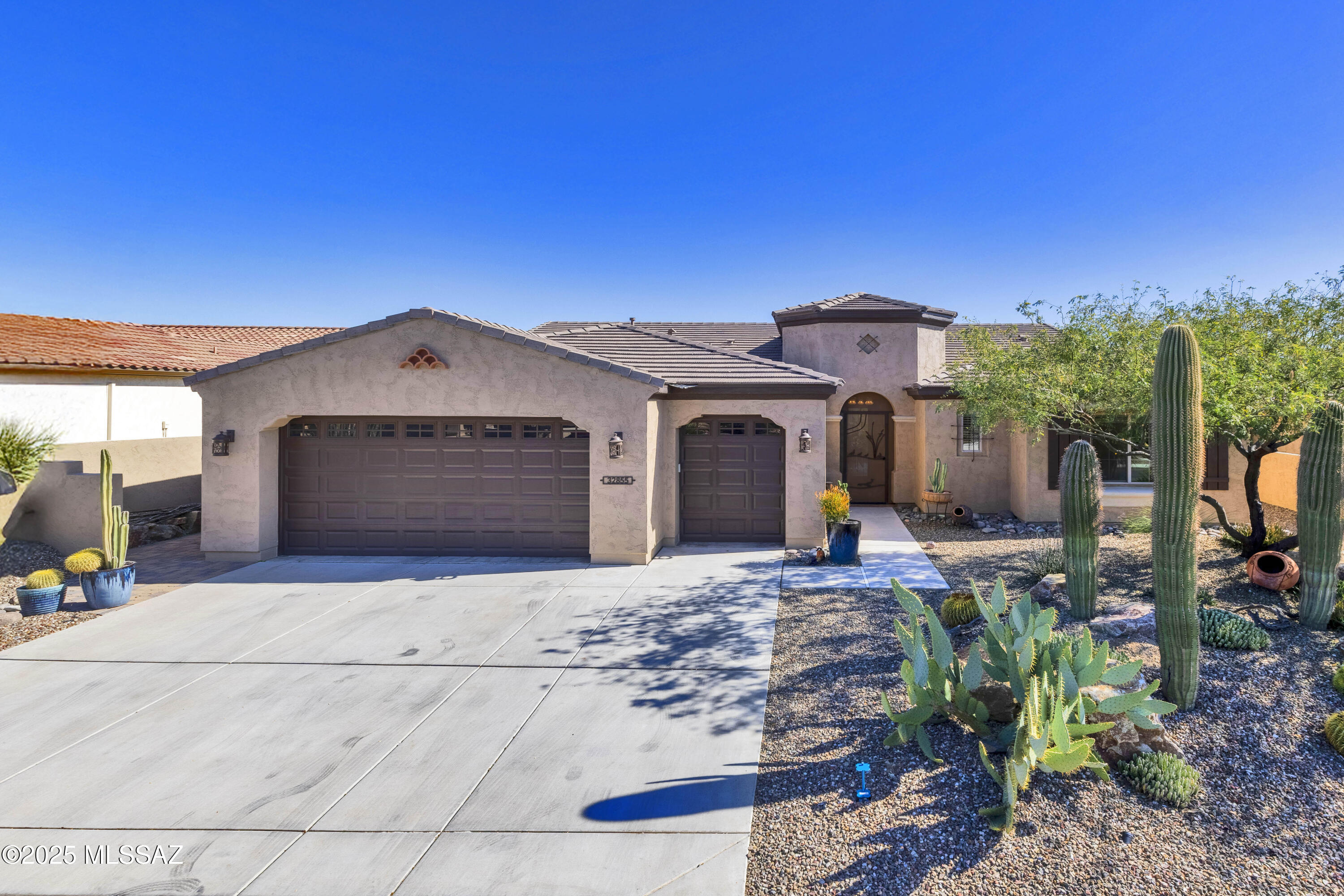 You will instantly fall in love with this stunning and highly upgraded Tesoro Premiere Series in SaddleBrooke Ranch! This home includes a Custom Tile Entry Way; 2-Bedroom En Suites; Powder Room, Great Room w/Media Alcove with 6-foot ceiling fans and to top if off a sliding glass wall that opens to covered patio; Dining Room; Grand Kitchen Island with adjoining Butler's Pantry and Walk-In Pantry; Dining Room; Spacious Office/Den that can double as an extra bedroom and comes with a Murphy Bed and matching book shelves on either side; Owner's Entry Valet with Cabinets; Walk-In Coat Closet; Walk Up Dry Bar; Large Laundry Room; Deep 2-Car and Golf Cart Garage w/Extra Storage; Covered Outdoor Living Space; and 9' and 11' foot ceilings through-out the home. The Master Bedroom En Suite has 2-Walk-In Closets; Dual Vanities; and 42" X 60" Walk-In Shower with Seat and power window shades. The 2nd Bedroom En Suite has a Walk-In Closet; and Shower. The view from the Great Room and Dining Room into the backyard and then to the majestic Mount Lemmon y is what truly defines this home and has to offer the new owner. Washer/Dryer and upgraded refrigerator convey with the home. The backyard has been meticulously landscaped. Whether you relax out in the exquisitely designed entertainer's backyard; the Spa, or under the covered living space, while BBQing and watching the Mountain Lemmon "turn pink," you will realize it does not get any better that this! Amenities added by current owners are Backyard - Tucson Rolling Shades, Extended Slate Patio, attached Pergola, Hot Tub, 6-foot ceiling fan, and a water feature. The home also has a custom-made front Screen door and a full house fire Prevention system.