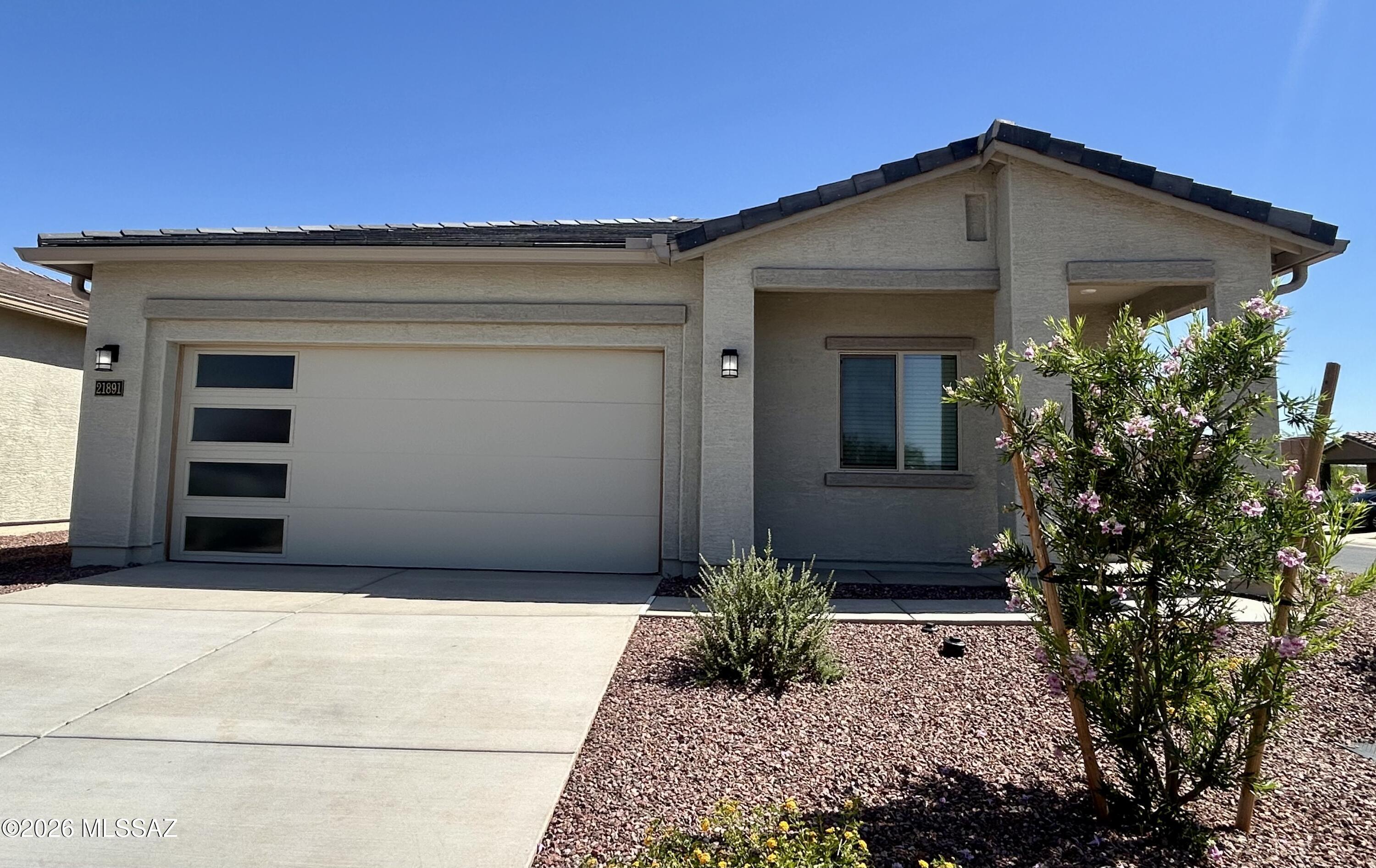 The Payson plan boasts a spacious 4-bedroom, 2-bathroom layout that's designed for comfort & togetherness. As you approach this home, the eye-catching exterior details, featuring a stylish tile roof, contemporary coach light, and a charming ¾ lite front door, set the tone for what awaits inside. Step through the door and be enchanted by the seamless flow of the Payson floor plan. A chef-ready kitchen takes center stage, overlooking the expansive dining area & inviting family room, creating the perfect space for gatherings & everyday living. When it's time to extend the celebration outdoors, you'll appreciate the generous covered back patio & the serenity of your private back yard. It offers a harmonious blend of style & functionality, making it the ideal residence for you and your family.