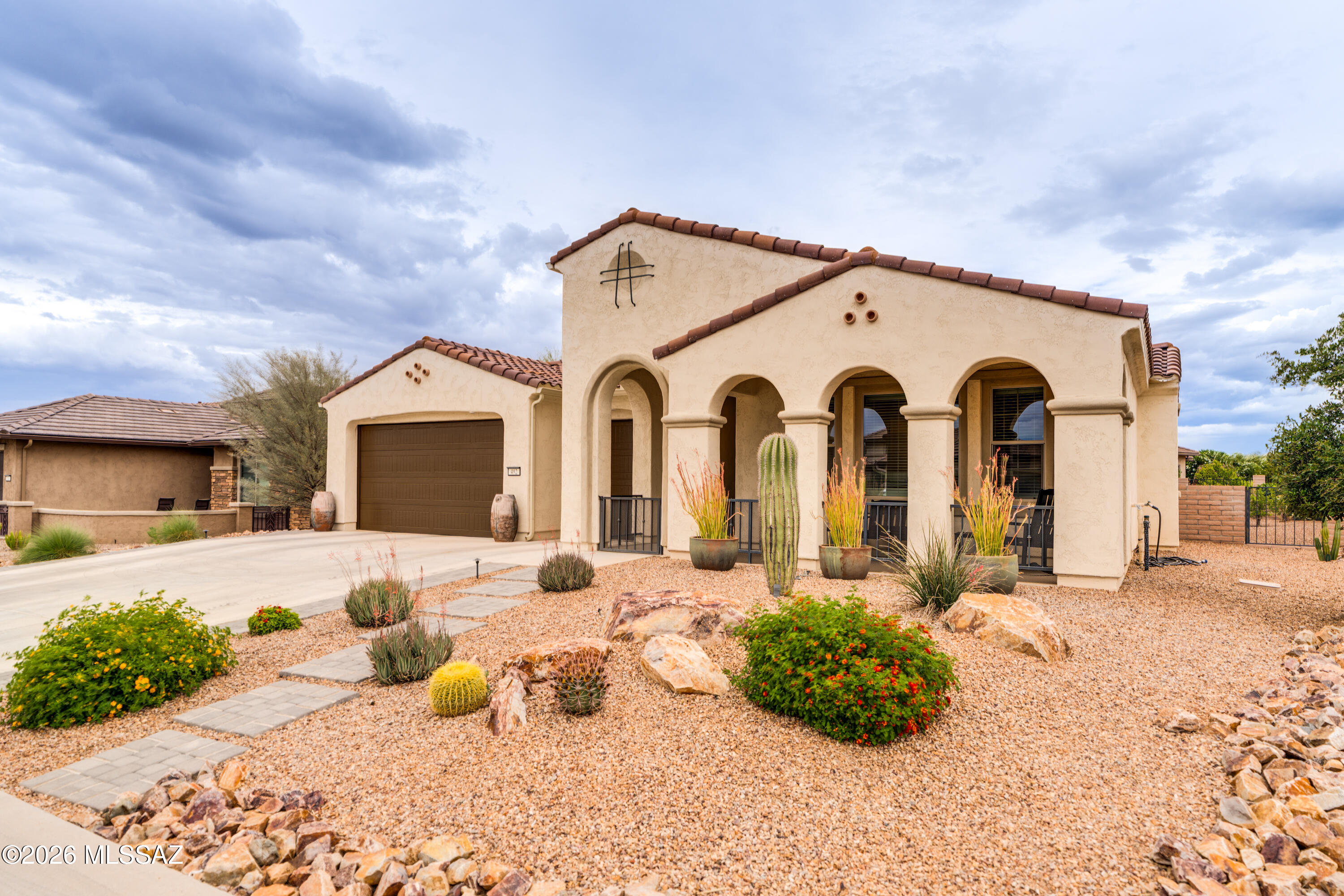 This exceptional 2021 Pavona model in Quail Creek offers 2,193 sq. ft., 2 BR, 2.5 BA, and a spacious flex room designed with versatility in mind. Attractive front desert landscaping and a welcoming front porch create outstanding curb appeal, while the entry foyer opens to an elegant interior featuring all tile flooring throughout, 5'' baseboards, 8' doors, and upgraded fans and lighting. The spacious great room is ideal for entertaining and includes a custom bar area with under-counter beverage cooler. The upgraded chef's kitchen showcases 41'' cabinetry, quartz countertops, stainless appliances including a 36'' gas cooktop, wall oven, and microwave, plus a butler's pantry with walk-in food storage pantry. A large center island with leather-finish granite, pendant lighting, and single-bowl composite sink anchors the space, while the adjacent dining area provides generous room for gatherings. The expansive owner's suite features a box bay window and a luxurious bath with dual vanities, quartz counters, jetted soaking tub, all-tile shower, and large walk-in closet. A split-bedroom design ensures privacy, with the guest suite offering its own en suite bath with all-tile shower. Double doors lead to the oversized flex room, ideal as a home office, media room, hobby, or craft space. A separate powder room is conveniently located for guests.

Enjoy seamless indoor-outdoor living with a rear covered patio extended an additional 10' in depth, extended paver patio areas, and a built-in natural gas BBQ. The beautifully landscaped rear yard includes artificial turf and four producing citrus trees -- lemon, lime, navel orange, and blood orange. Additional highlights include sound attenuating common walls, stylish two-tone paint, and a spacious laundry room. Fully insulated extended-length garage with golf cart bay, side service door, and 240V service for an electric vehicle, mini-split, or high-amp appliance. Energy-saving solar helps keep electric bills low, completing this beautifully upgraded home designed for comfortable Arizona living.