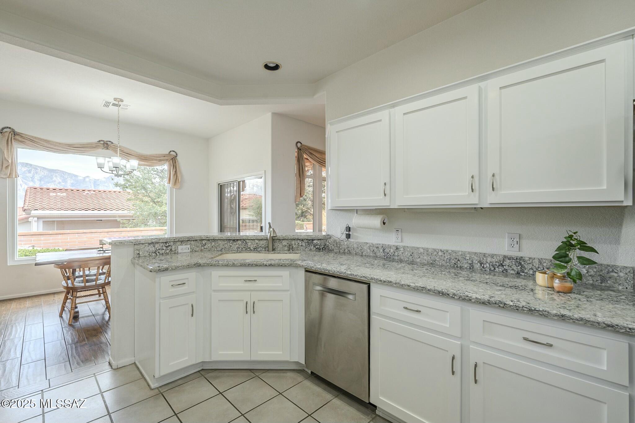 Enjoy this great retirement vibrant community with access to numerous amenities and activities. This is an extended Mayfair model with 1,841 square feet.  The main living area boasts a cozy fireplace, creating a warm and inviting atmosphere.  Abundant natural light flows throughout the space. The kitchen features ample countertops, cabinetry with pull-out shelving and granite countertops and stainless steel appliances.  Generous den space off the kitchen and nice view window in the dining room.  Generous primary bedroom with sitting area and doors that lead to the back patio.