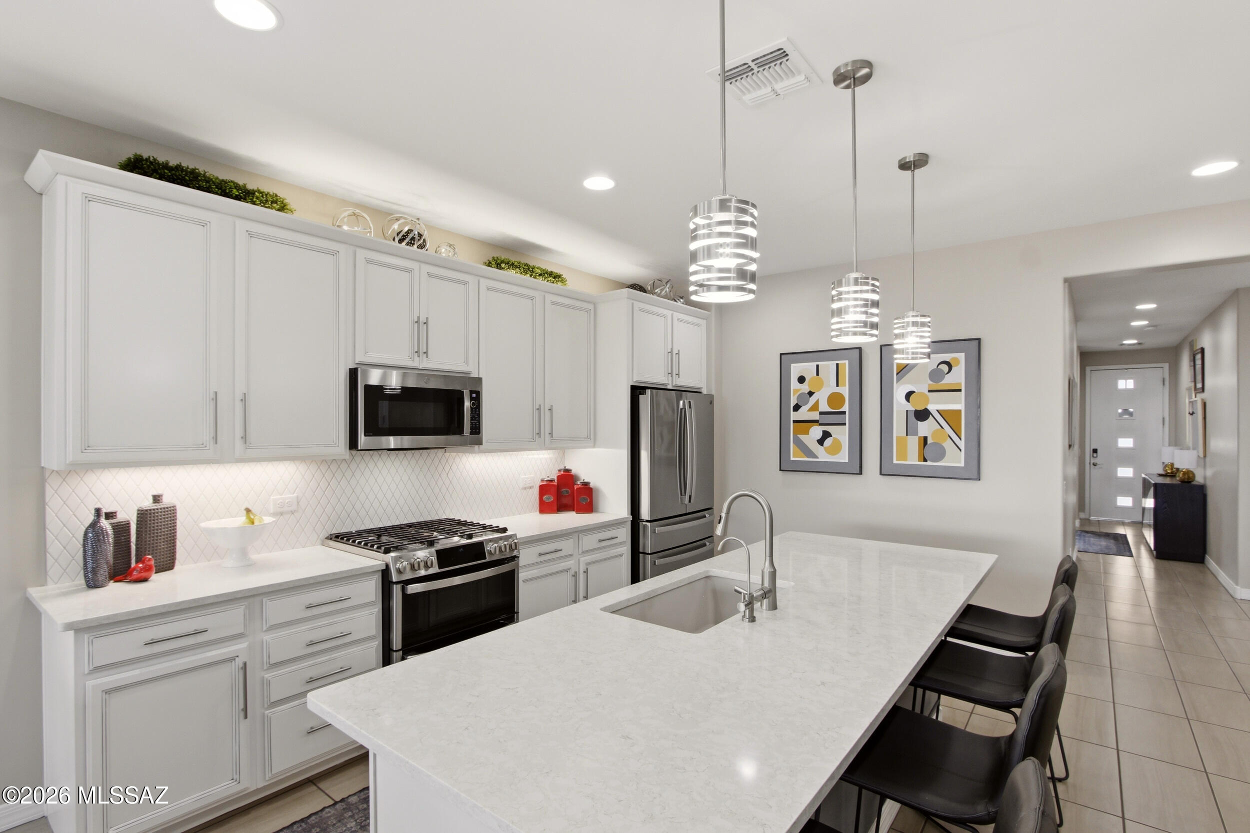 VA ASSUMABLE LOAN AVAILABLE TO ALL BUYERS AT 2.5% INTEREST RATE -- a rare and powerful opportunity in today's market! Range price- Seller will accept or counter offers in between $450,000 and $490,000.

Welcome to 12364 N Amberwood Place, a highly upgraded Richmond American Sapphire model built in 2021, offering 4 bedrooms, 3 full baths, plus a versatile den that can easily convert to a 5th bedroom. With 2,040 sq. ft. of thoughtfully designed living space, this home stands out from new construction--packed with premium upgrades, completed landscaping, and move-in ready convenience that you simply won't get at the builder's base price.

Situated on an upgraded lot with no direct rear neighbors and partial mountain views, this property offers privacy and a beautifully designed outdoor retreat. The professionally landscaped backyard features mature palm trees, a Meyer lemon tree, artificial turf, extensive paver work, covered patio, and irrigation--perfect for entertaining or relaxing. The front yard is equally impressive with custom landscaping, a decorative pony wall, and HOA-approved Live Oak trees.

Inside, you'll find tile flooring throughout, 8-foot doors, custom baseboards, and fresh 2024 interior paint. The great room is a showstopper with a custom feature wall, built-in shelving, LED accent lighting, and a 62" electric fireplace.

The chef's kitchen is fully upgraded with:

* 42" cabinetry with crown molding & pull-out shelves
* Quartz countertops & custom backsplash
* GE Profile gas cooktop, double ovens & convection microwave
* Bosch 3-rack dishwasher
* Large island with seating for 4-5
* Walk-in pantry + additional pantry
* RO system, under-cabinet LED lighting, and smart features

This home sale also includes the Samsung TV in the custom built-in, Sonos sound system, all appliances including a new refrigerator, washer and dryer.

The primary suite offers dual walk-in closets (including custom built-ins), additional windows, and a spa-like bath with floor-to-ceiling tiled shower, rain head, glass enclosure, and quartz dual vanity.

Additional highlights include:

* Smart home system + Ring security
* Gas HVAC with dual Honeywell smart thermostats
* Owned water softener system
* Gutters directing water away from the home
* Extended 2-car garage with overhead storage racks and custom cabinetry
* Ceiling fans throughout interior and patio

Compared to the same model currently being built in Gladden Farms at ~$520,000, this home includes tens of thousands in upgrades--landscaping, appliances, cabinetry, lighting, window treatments, garage storage, and more--already completed for you.

This is the total package: better than new, fully upgraded, and priced with a 2.5% assumable loan advantage. Don't miss it!