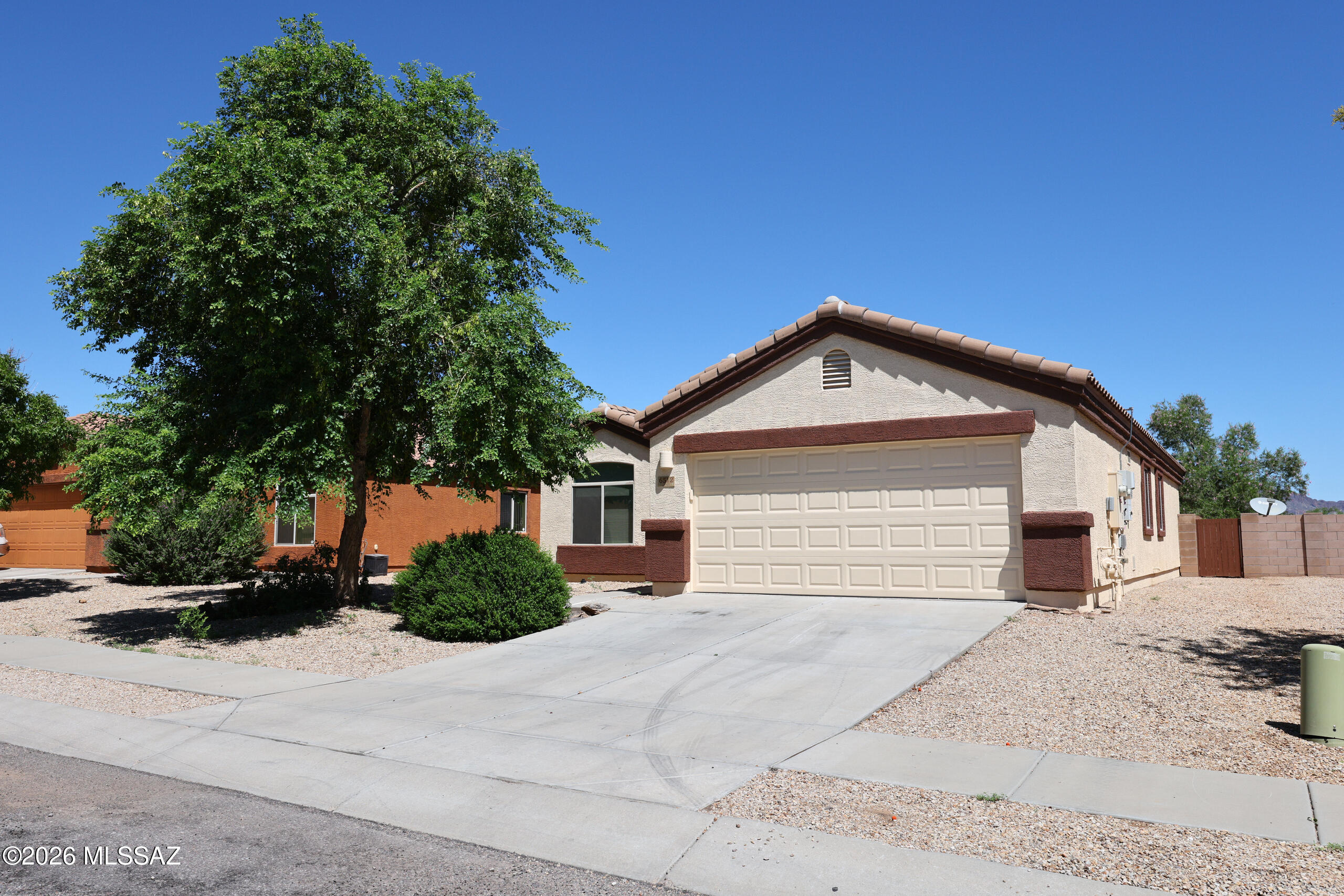 Located in the desirable Star Valley community, this single-story home offers 3 bedrooms, 2 bathrooms, and a comfortable great-room floor plan on a .14-acre lot. The light and open interior features a breakfast nook, maple cabinetry, and 16x16 tile flooring throughout the main living areas. Freshly painted inside and out, the home is move-in ready and also features Tesla solar for added energy efficiency. Enjoy a spacious backyard with a covered patio, offering plenty of room for outdoor dining, entertaining, or relaxing. Additional highlights include a 2-car garage and convenient access to nearby community parks, walking paths, and jogging trails. A great opportunity to enjoy comfortable living in an established Southwest Tucson community.