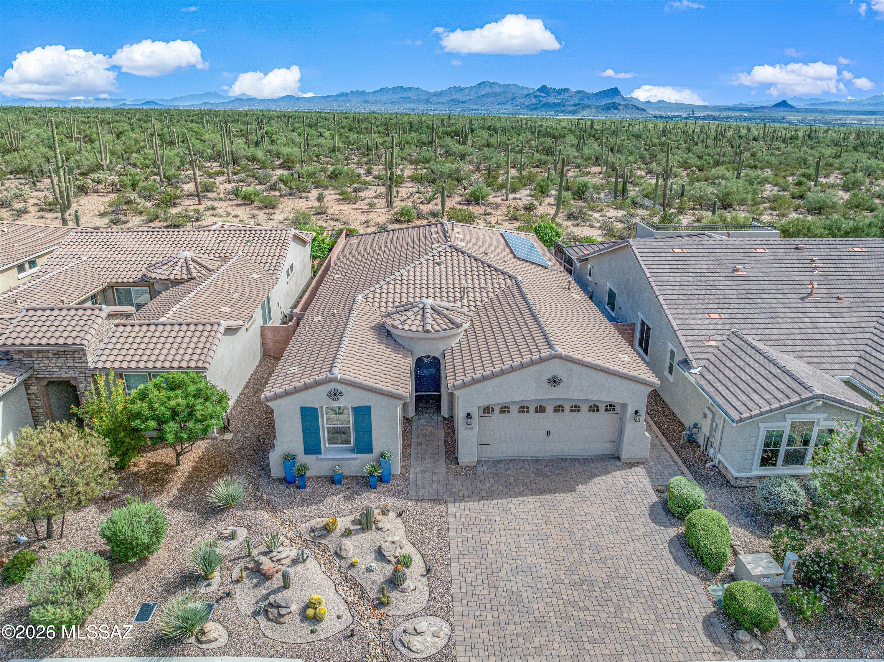 Welcome home to this beautifully designed desert retreat, filled with thoughtful upgrades and designer touches. The open great room and kitchen create the perfect setting for entertaining, featuring a generous island and oversized sliding door opening to the patio and unobstructed desert views. Offering 2 bedrooms plus a spacious office/flex room with glass double doors that can easily convert to a 3rd bedroom. The private guest wing adds comfort for visitors. Enjoy solar, motorized patio shades, a primary walk-in shower, secondary bath soaking tub, additional backyard patio, putting green, extended-width paver driveway, upgraded baseboards and beautiful finishes throughout. Arizona living at its best!
.7 miles from Mountain West Park Pickleball, Basketball, Tot Lot and Walking Trails
