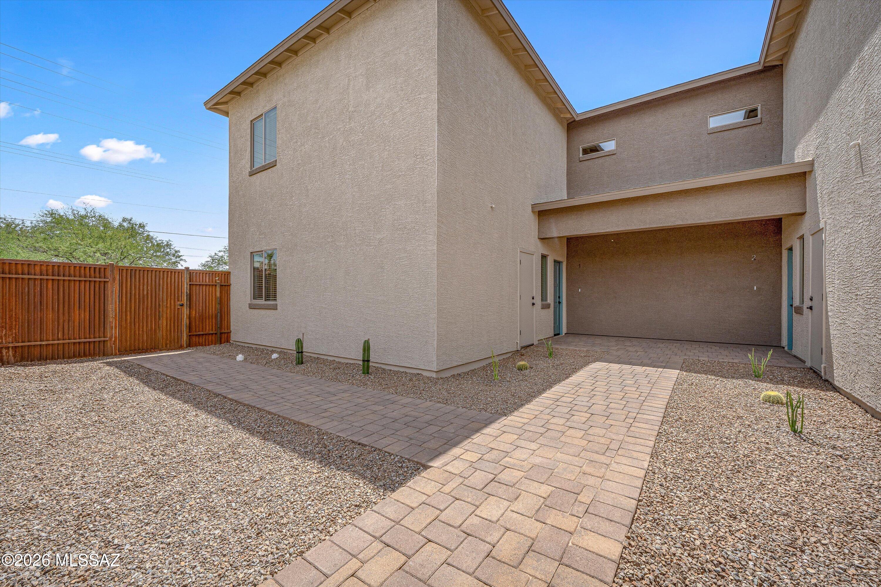 Brand new 4BR/3BA, 2 story home with modern comfort & thoughtful design. Open-concept features a spacious great room that flows into the kitchen with a large island, SS appliances, pantry and gorgeous cabinets. 1BR/BA w/large walk-in closet on the first floor. Under Stair Storage. Upstairs, enjoy generously sized bedrooms, Primary Suite with large Walk In Closet and Bath with Shower. The large laundry room is complete with washer, dryer, cabinets, and folding area. Easy-care luxury plank vinyl flooring runs throughout the home. Step outside to a private yard with a paver patio, perfect for relaxing or entertaining. Off-street parking included. Ideally located near the U of A, Pima CC and downtown with quick access to dining, shopping, and entertainment. 2 homes available!