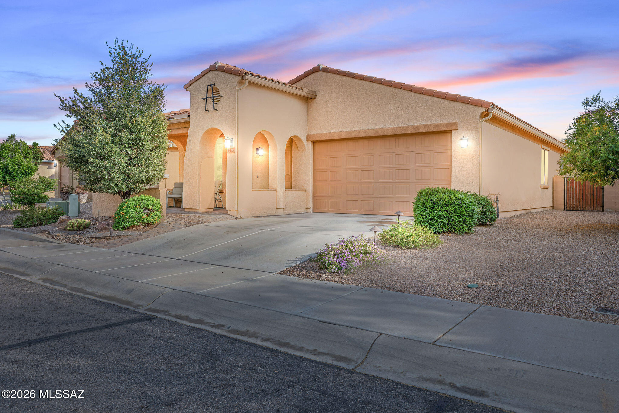 Nestled within the gated Pines Golf Course community, this exceptional residence, built in 2012, offers a rare opportunity to enjoy golf course living with sweeping mountain views and no neighbors behind. Beautifully maintained and thoughtfully designed, this three-bedroom home features a desirable split floor plan and an open-concept layout that blends comfort, elegance, and functionality. The interior showcases wood plank flooring, crown molding, and custom paint throughout, creating a warm and refined atmosphere. At the heart of the home, the well-appointed kitchen features granite countertops, a travertine backsplash, stainless steel appliances, double ovens, staggered cabinetry with glass insets, and a spacious walk-in pantry. The expansive breakfast bar with seating for four flows seamlessly into the great room, where a 10-foot sliding glass door with custom shade fills the space with natural light and invites the outdoors in.
The backyard offers a peaceful retreat designed for both relaxation and entertaining, highlighted by a courtyard entry, brick pavers, a travertine patio, and mature Meyer lemon and lime trees, all overlooking the beautifully maintained golf course. Additional features include epoxy-coated garage flooring and a long list of thoughtful upgrades throughout. Ideally located near shopping, dining, schools, parks, walking trails, golf, and the community pool, this home offers the perfect balance of luxury, convenience, and lifestyle. This remarkable property is truly loaded with upgrades--please see the attached feature list for additional details.