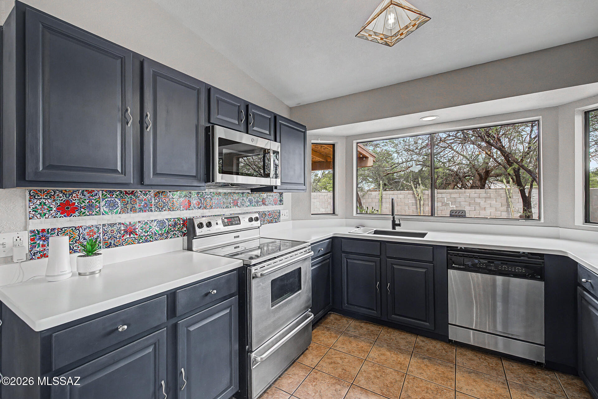 SAY GOODBYE TO CRAMPED FLOOR PLANS AND SKY HIGH UTILITY BILLS! Welcome to this beautifully updated 1,412 Square foot single-story home in Tucson's desirable Midvale Park. Forget chopped up layouts with tiny, unusable bedrooms-this rare 2-bedroom footprint is designed for spacious open-concept living and maximum efficiency. Fully modernized kitchen boasting sleek quartz countertops and updated appliances. Brand new HVAC system installed in 2022 for total peace of mind. ULTRA LOW ELECTRIC BILLS- beat the Arizona summer heat guilt-free! This home features fully PAID-OFF solar panels installed in 2024. This passes immediate, massive monthly cash-flow savings directly to the new owner. Step outside to a low-maintenance desert backyard, perfectly designed for effortless ''lock-and-leave'' conven Arizona living. Ideally located near shopping, dining, parks, major routes, and everyday conveniences, this home is a wonderful opportunity you will not want to miss.