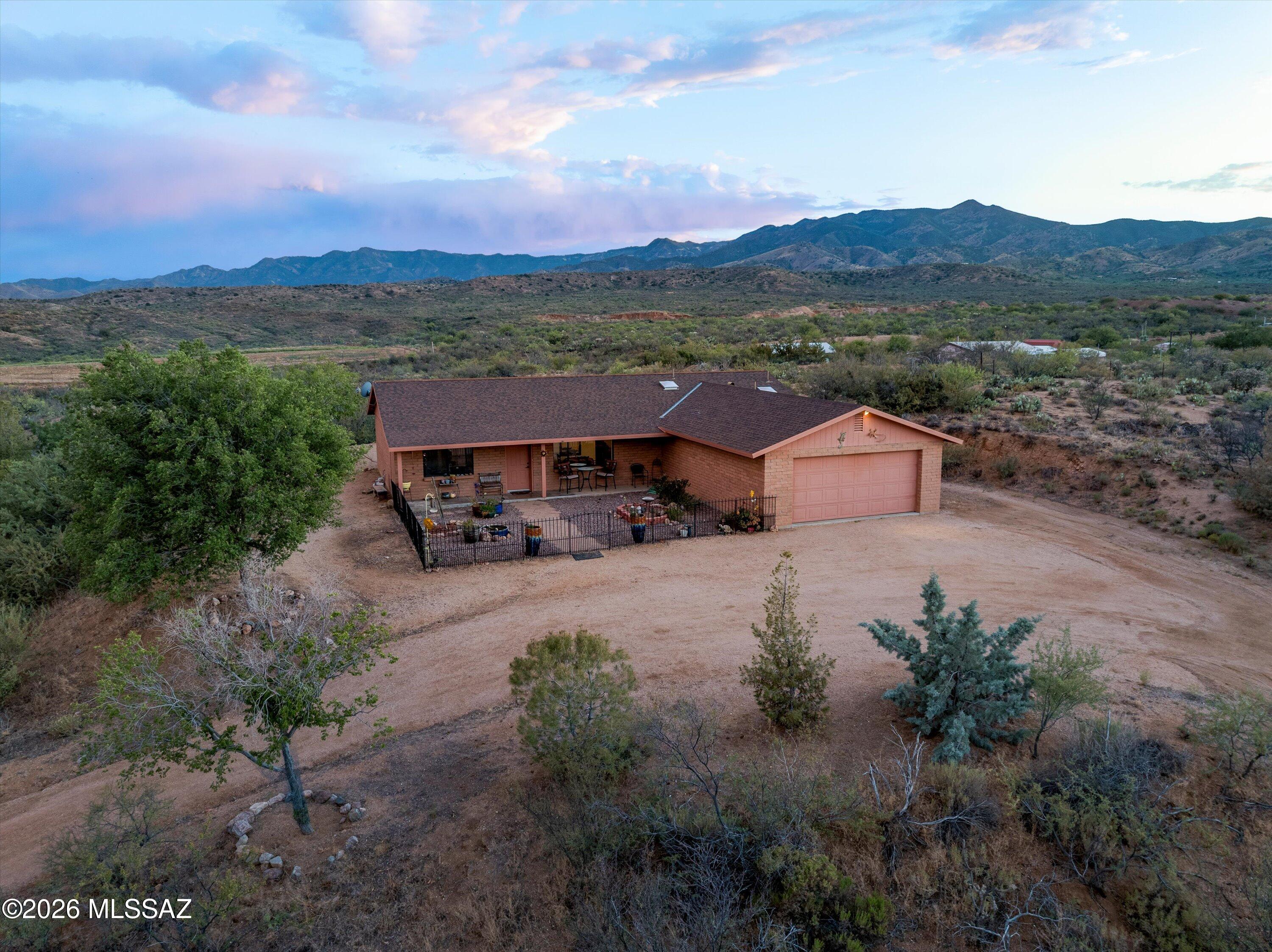 This block home on 5.02 acres of fully-fenced horse property is the perfect opportunity to enjoy rural living in the peaceful town of Oracle! Take in the panoramic mountain views and the variety of wildlife from the large covered porches and other outdoor seating areas. Horse-ready, with a shaded corral and shed for hay/tack. The spacious kitchen features stainless steel appliances and a skylight. The attached two-car garage provides protection for your vehicles or toys, and the laundry room has extra room for storage. This one-owner, Soule-built home has been well maintained and well loved!