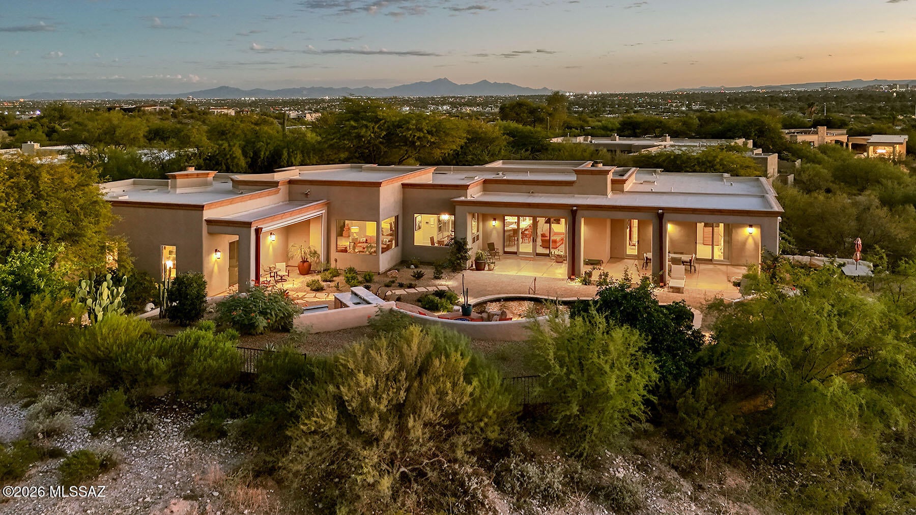 STUNNING HOME IN MAN GATED CATALINA FOOTHILLS ESTATES  #10!  VERY PRIVATE
3.3 ACRE LOT WITH SANTA CATALINA  MT, TUCSON MT, SUNSET AND CITY VIEWS!! Enjoy
spectacular views from the house as well as the yard and patio areas.  Long paver driveway, with night lighting and beautiful plantings lead to this
lovely contemporary home! ALL tile floors except carpet in 2 bedrooms; beautiful solid core, interior, wood doors; recessed lighting in all rooms; 2 gas fireplaces with glass rocks + firepit.  One of the best kitchens with space for many cooks.  Beautiful granite, top appliances, breakfast bar, center island, walk in pantry and dry bar area.  Kitchen opens to family room and informal eating area.  Elegant primary bedroom has a wall of built in book shelves,... SEE ''MORE'' AS A CONTINUATION corner fireplace, sliding doors to private covered patio with an automatic sun screen, two fabulous walk in closets, separate vanity areas, walk in shower and soaking tub.  Formal Living  Room looks out to the north mountains and formal dining room can easily seat 10-12.  Office/den adjacent to primary bedroom features beautiful wood built in shelves, cabinets and file drawers.   Split bedroom plan.  Two lovely guest suites both have their own 3/4 baths with walk in showers.  Bedroom 3 could also be a work out room, office or crafts room.  3/4 Bath opens to the backyard.
Laundry Room is off the kitchen as is the 3 car, extended length garage. Garage has built in shelving on one wall, HVAC unit &  separate storage room with shelving.

Truly lovely backyard for family enjoyment and entertaining. Long covered porch off the family room has ample space for outdoor entertaining, 4 ceiling fans, ceiling speakers and an automatic screen on the west side of the porch.  The covered porch off the primary bedroom also has an automatic screen, ceiling fan and speakers.  Gorgeous pebble tech pool features rock waterfalls and can be heated.  Separate in ground pebble tech spa has amazing sunset views.  West patio looks out to the Tucson Mountains, Sunsets, A Mountain, U of A and downtown.  Outdoor kitchen has a bar area, built in BQ with a side spot light, sink and refrigerator.  Gather round the fire pit on cool nights.  Lush landscaping includes 6 citrus trees, a fig tree, rose garden and low care plants all on a drip system. Outdoor lighting.  Very private backyard for your enjoyment.  Look under the Document Tab for additional information.  THIS IS A VERY SPECIAL HOME - A TREASURE!
