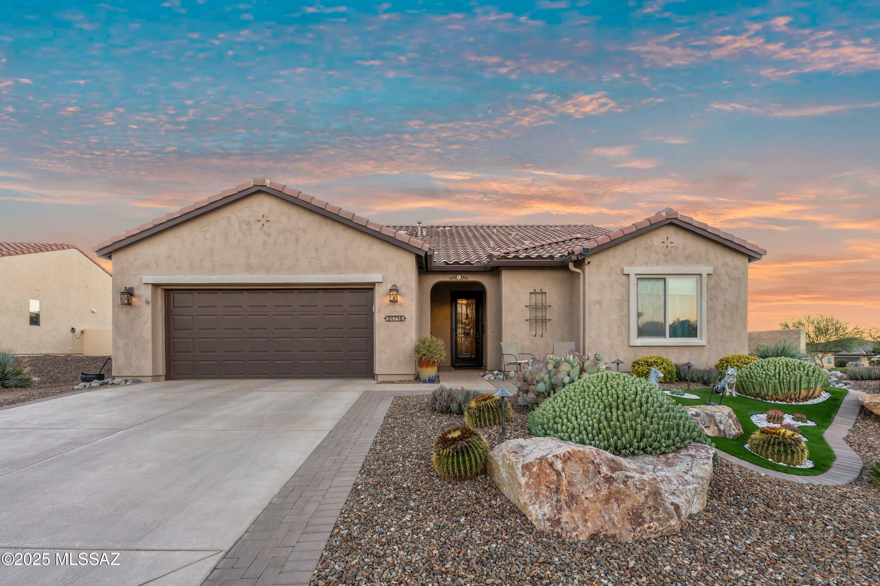 Discover the charm and functionality of this beautifully appointed Artesa model, which can be purchased fully furnished as a turnkey opportunity! Nestled on an upgraded corner lot, within walking distance to the amenities, this home offers exceptional privacy w/fully-fenced professionally designed backyard, adorned w/fruit trees & distant mountain views. Outdoor living is elevated with a covered screened patio with fire table, an extended paver patio, a lighted pergola complete w/ misters, along w/solid side wall to block any traffic noise--perfect for relaxing or entertaining. The gourmet kitchen showcases Slate appliances, gas range, pendant lighting, under-cabinet illumination, a Blanco sink, trash pull-out drawer, pantry closet.  Oversize garage can accommodate two cars & a golf cart.