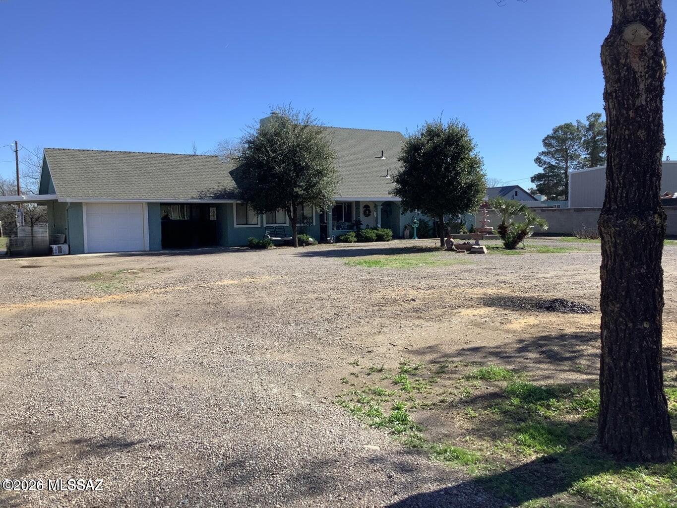 A beautiful 2-story 2486 sq ft home in a nice location close to everything in town. It sits back off road but still has plenty of space on this .78-acre property for an RV with its own septic & full hook-up or build a guest house. The house boasts several covered patios to enjoy the fenced backyard or sit out front & take in the views of Mt Graham. Entrance foyer & step-down living room w/wood burning fireplace & French Doors lead into the family room w/sliding glass door to one of the carports. Large kitchen with plenty of storage, breakfast bar & dining area with a sliding glass door to the yard, a big walk-in pantry & large mud/laundry room. There are two primary suites, 1 upstairs with sitting room & 1 downstairs with ADA bathroom. 2 guest bedrooms & guest bathroom downstairs too.