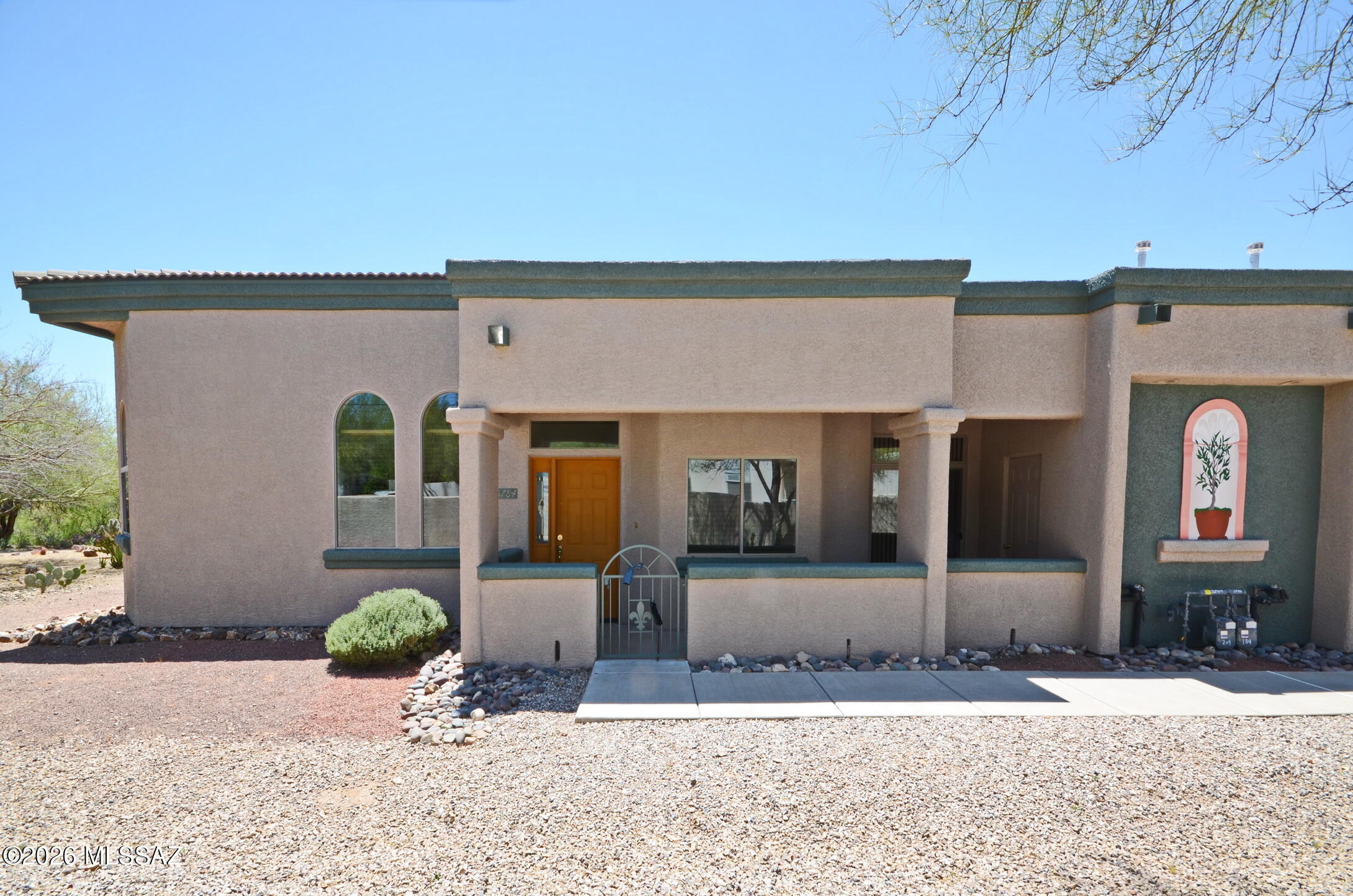 Stunning townhome with high ceilings open floor plan with Den/Office for extra room with double doors for privacy.  All tile throughout.  Spacious kitchen with extra cabinets for storage.  Enclosed patio with security gate. Close to shopping transportation I-10 I-19 U of A and Pima Comm College West and Pima Downtown.