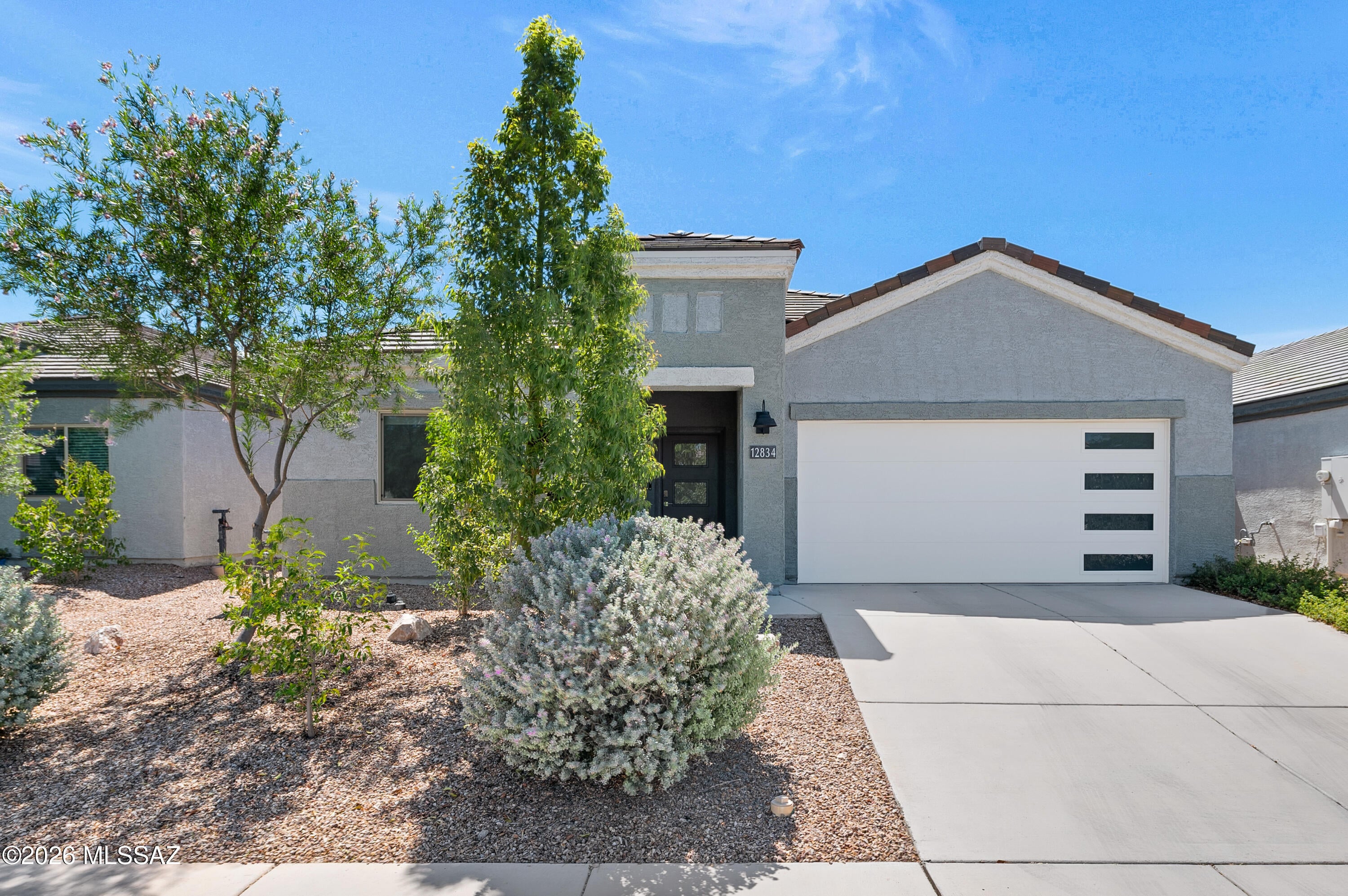 Gorgeous DR Horton Cali floor plan offering 1,823 SF with 4 bedrooms, 2 bathrooms, soaring 9-foot ceilings, and stylish plank tile flooring throughout the main living areas.The beautifully appointed kitchen is the heart of the home, featuring an expansive center island with sit up bar seating overlooking the great room, quartz countertops, 36-inch gray shaker birch cabinetry with upgraded hardware, a crisp white subway tile backsplash, and stainless-steel gas appliances.The spacious primary suite offers a generous walk-in closet and a comfortable private retreat. Step outside to the beautifully landscaped backyard featuring custom pavers, covered back patio, artificial turf, and plenty of space to create your dream outdoor oasis with a future pool and outdoor kitchen. Thoughtful upgrades and energy-efficient features include a smart home system, leased solar with low monthly electric bills, tankless water heater, soft water system. 

Complete with a 2-car garage and ideally located near the neighborhood park, highly rated Vail schools, Davis-Monthan Air Force Base, and convenient access to I-10. Immaculate, upgraded, and move-in ready--this home truly has all the bells and whistles!