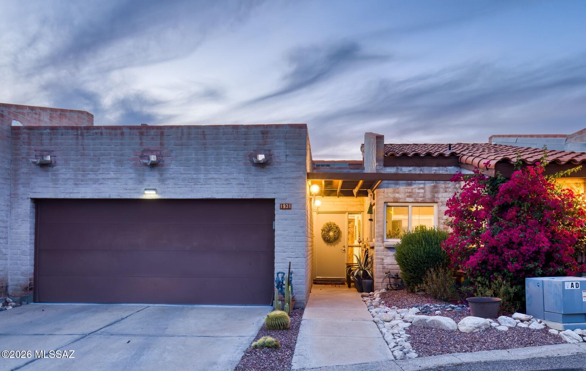 Sophisticated and effortlessly refined, this fully remodeled Foothills Ridge townhome is privately positioned on a scenic hilltop along the coveted Campbell corridor in the Catalina Foothills. Surrounded by a saguaro-studded bosque and framed by sweeping Catalina Mountain views, the home captures the essence of Sonoran Desert living, with both upper and lower balconies perfectly oriented for Tucson's vibrant, ever-changing sunsets. Inside, soaring vaulted ceilings with exposed beams and a dramatic wall of windows fill the upper-level living spaces with natural light throughout the day. The thoughtfully designed floor plan places the main living areas upstairs, including an inviting primary suite that feels like a private retreat. Here, a picture window frames the surrounding landscape, while the remodeled spa-inspired bath offers a dual vanity, expansive tiled walk-in shower, and a custom-designed California Closet.
The beautifully updated kitchen blends style and function with quartz countertops, stainless steel appliances, modern cabinetry, and a versatile breakfast nook, ideal for casual dining or a tucked-away workspace. Adjacent dining and living areas create a warm, welcoming environment, anchored by a fireplace and designed for both relaxed evenings and effortless entertaining.
The lower level offers two additional bedrooms, providing ideal separation for guests, family, or flexible living space. Additional enhancements include hardwood flooring, a reimagined laundry room with built-in storage, a convenient powder room, updated dual-pane and clerestory windows, and a spacious two-car garage.
Residents of Foothills Ridge enjoy access to community amenities, including a pool and tennis court, enhancing a lifestyle that balances comfort, privacy, and convenience.
Perfectly situated near St. Philip's Plaza and the vibrant Rillito Park Farmers Market, this exceptional location places some of Tucson's most beloved dining, shopping, and outdoor experiences just moments away. The nearby Loop offers miles of walking and biking trails, while La Encantada and AJ's Fine Foods are just up the hill, bringing everyday convenience to an elevated Foothills lifestyle.
