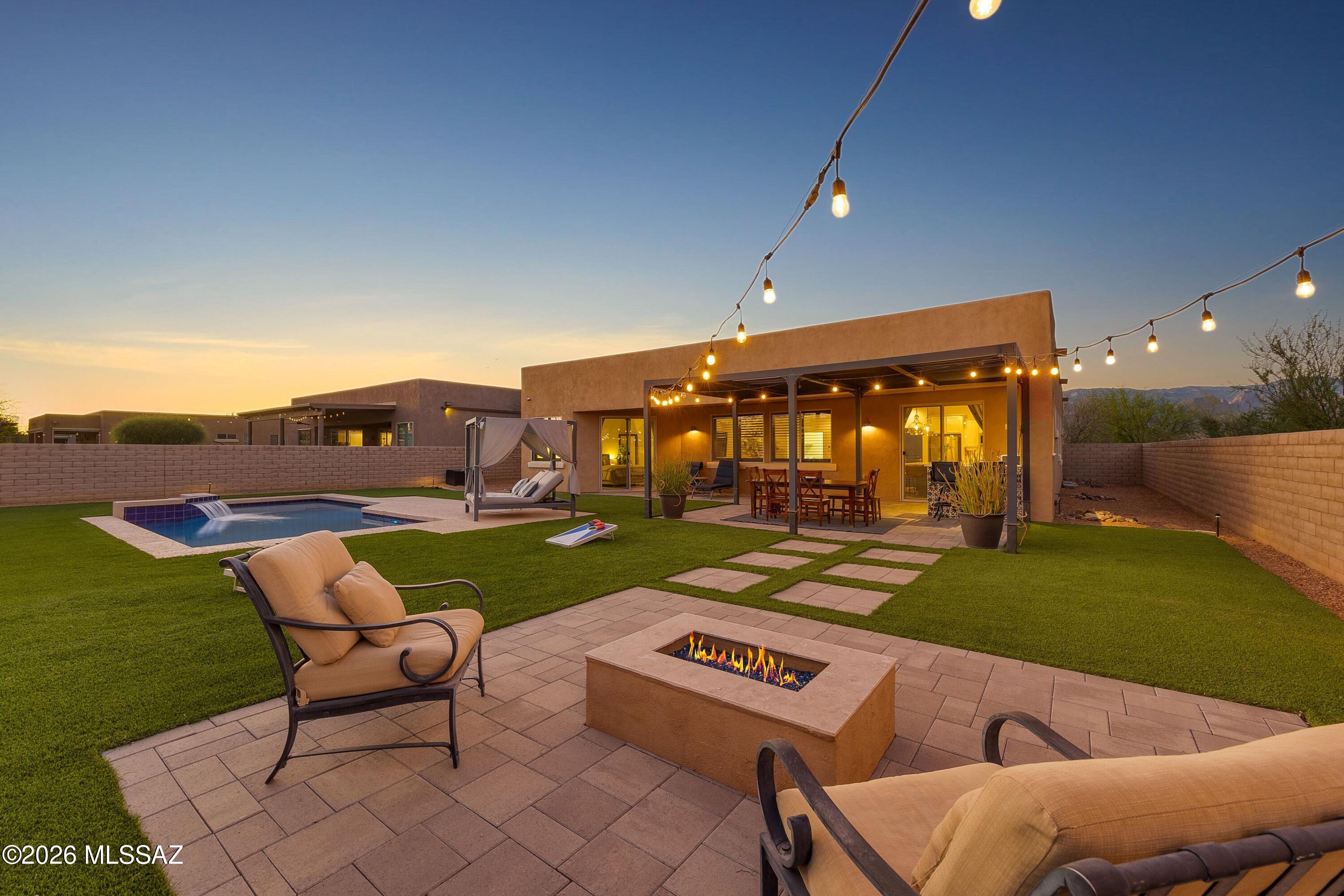 Welcome to Haciendas at Wrightstown, an intimate boutique community by Mesquite Homes. Tucked away in a quiet and private setting, this modern 3 bedroom, 2 bath home with a 3 car garage sits on a generous 0.24 acre lot with no neighbors to the east, offering exceptional privacy. Inside, the light filled great room floor plan with split bedrooms is ideal for both entertaining and everyday living. The stylish kitchen features a spacious built in dining area, quartz countertops, custom tile backsplash, stainless steel appliances, and a pantry.  The expansive primary suite includes access to the backyard, dual vanities, a glass enclosed shower, and a walk in closet.  Step outside to your private oasis, thoughtfully designed for relaxation and outdoor entertaining.  Enjoy a saltwater pool, built in BBQ, firepit, covered patio, and an additional covered outdoor space perfect for lounging or dining. Additional features include a front courtyard,  plantation shutters, wood look tile flooring throughout, and much more. Discover the comfort, privacy, and convenience this desirable East Tucson location has to offer!