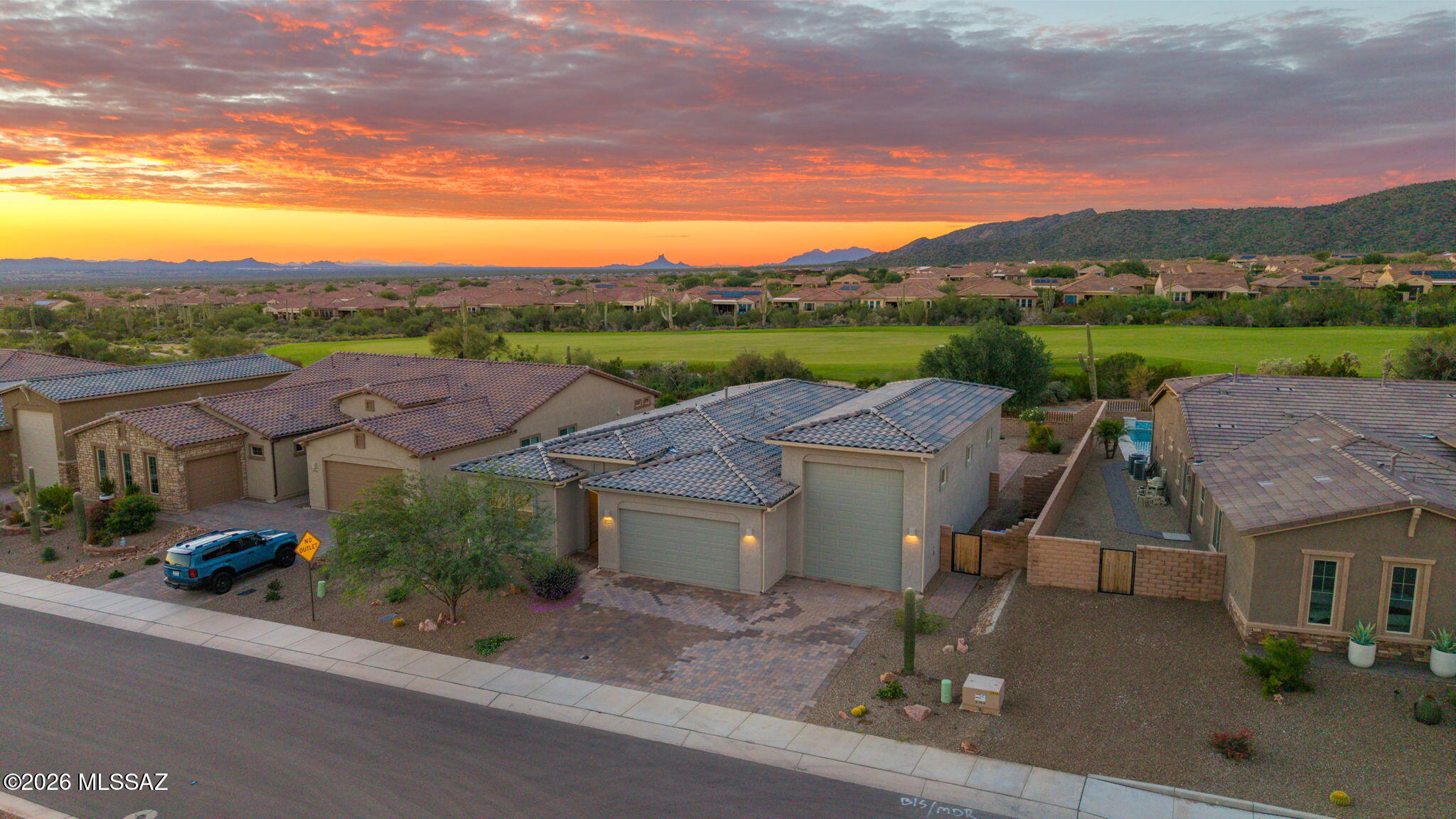 Overlooking the 9th hole of The Gallery Golf Club, this newer single-story Dove Mountain home combines golf course and mountain views with a rare dedicated RV garage. Offering 4 bedrooms, 2.5 baths and 2,406 sq ft, the open floor plan is designed to take advantage of its beautiful Sonoran Desert setting. The spacious great room flows into the dining area and kitchen, where a large center island, generous cabinetry and upgraded appliances create an easy space for everyday living and entertaining. Oversized sliding glass doors connect the interior to the covered patio and backyard, with views of the golf course, surrounding desert and mountains beyond. The private primary suite is separated from the secondary bedrooms and features scenic views, a large walk-in closet and oversized walk-in shower. Three additional bedrooms offer flexibility for guests, a home office or hobby space. A standout feature is the garage setup: a traditional two-car garage plus a dedicated RV garage with exceptional space for an RV, recreational toys, workshop, storage or golf cart. Located in gated Dove Mountain near The Gallery Golf Club, hiking and biking trails, resorts, dining and the Tortolita Mountains. A rare combination of 9th-hole golf course views, mountain scenery, newer single-story living and dedicated RV garage space.