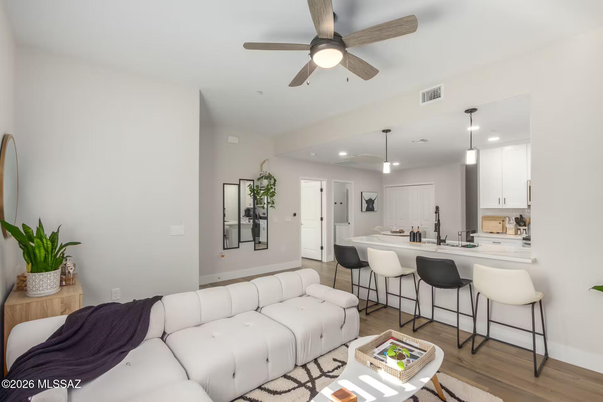 Welcome to this charming 1 bed, 1 bath condo plus den at the base of the foothills in a desirable gated community with pool and jacuzzi. Located on the ground floor for easy access, the home features durable vinyl flooring throughout and a modern kitchen with quartz countertops and stainless appliances. The bright den offers flexible space for an office or extra sleeping area. Steps from abundant shopping, dining, and the scenic riverwalk, this property is perfect as a comfortable primary residence or a profitable Airbnb currently operating successfully as a short-term rental. Option to purchase fully furnished for a turnkey investment or move-in ready lifestyle. Secure, serene, and ideally situated for mountain access and city conveniences. Schedule your showing today and don't miss out!