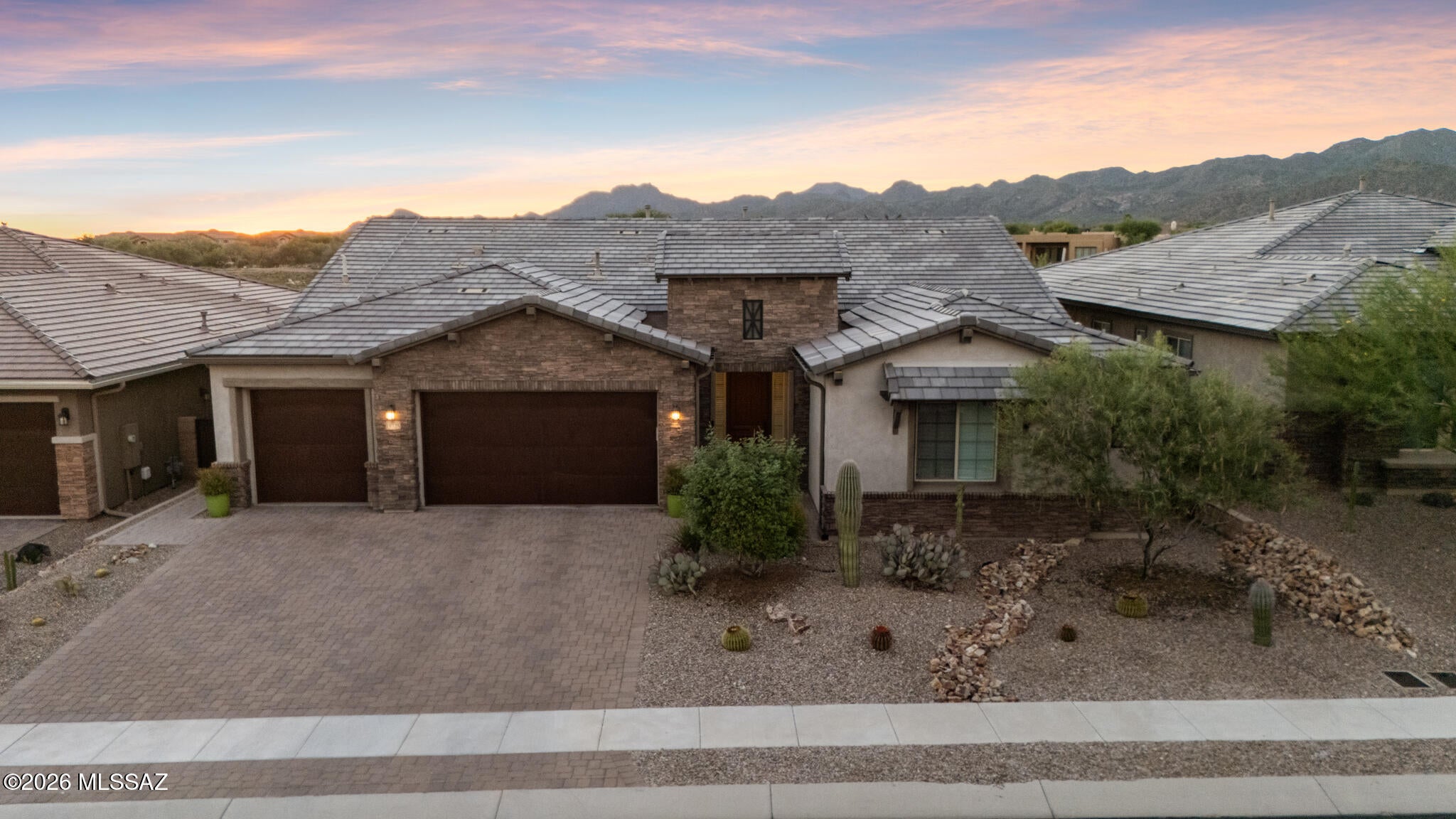 Welcome home! Nestled within a gated subdivision in the highly desirable Rancho Vistoso community of Oro Valley, this beautiful property embodies the essence of a desert retreat. Built in 2021, this home offers 3,145 sq. ft. of living space, featuring 3 bedrooms, 2.5 bathrooms, inviting living areas, and a beautifully landscaped backyard. Upscale finishes and smart-home features throughout, including remote-controlled window coverings, add modern convenience and functionality. 
The well-appointed kitchen serves as a central gathering space, featuring granite countertops, stainless steel appliances, a pot filler, wine cooler, and a spacious center island with additional seating. The thoughtfully designed interior also includes a formal dining room, den, dedicated office space and a gas fireplace in the great room, creating a comfortable and versatile living environment.
Recently updated this summer, the backyard and patio are designed for exceptional outdoor living, entertaining, and relaxation. Enjoy afternoons by the pool, prepare meals in the outdoor kitchen, fire up the barbecue, or gather around the outdoor fire pit as the sun sets over the surrounding mountain landscape. Artificial turf, mature fruit trees, and scenic mountain views enhance the outdoor setting, while the absence of rear neighbors adds an extra measure of privacy.
With its modern amenities, thoughtfully designed living spaces, and inviting indoor-outdoor flow, this exceptional residence offers a wonderful opportunity to experience the best of Oro Valley and the Southern Arizona lifestyle.