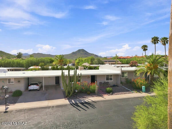 Welcome to Playa de Serrano, a fabulous adult community tucked in the heart of West Tucson. This property is like a warm hug and immediately feels like home. It's clean, inviting, low-maintenance, has beautiful views from the living room and front porch, and is close to amenities even though it feels like your sitting right at the base of the mountains. The community pool is just around the corner and offers a place to relax and have a coffee or take a dip. The home has recently been updated with new texture and paint, flooring, some lighting fixtures, and a custom therapeutic walk-in tub. The kitchen offers plenty of storage, and the laundry room/utility offers even more! Security doors provide extra protection at both the front door and carport entrance. The Arizona room/ laundry room, is fully heated and cooled. Come. See. Stay!