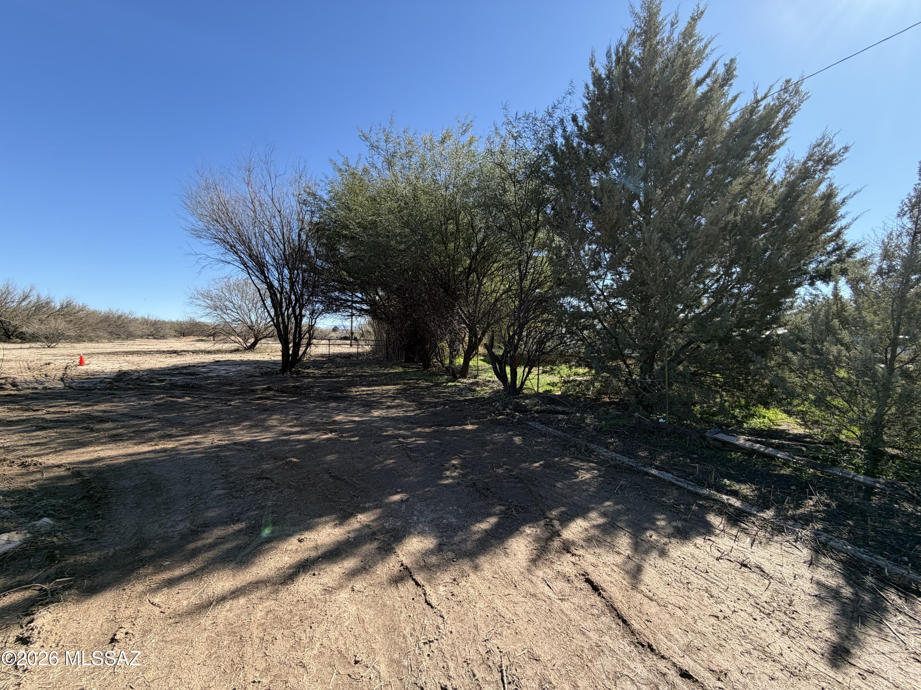 VACANT LAND located at 1055 N Pomerene Rd in a rural residential area with surrounding homes. This cleared parcel previously had a mobile home on site and includes existing horse corrals, making it a great opportunity for buyers looking to build, place a manufactured home, or invest in the desirable Pomerene area. Utilities are available at the property, including gas, electric, and water. Historical septic documentation has been located; however, buyer to verify condition and suitability for intended use. Buyer to verify all facts including zoning, utility availability, building requirements, and property suitability.