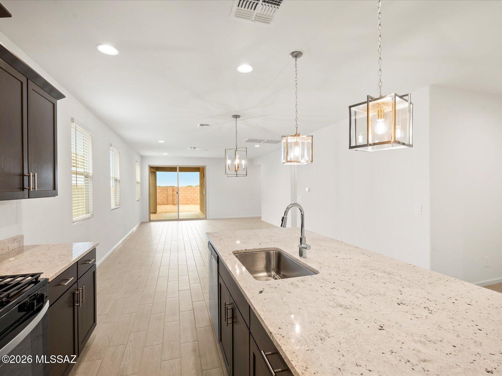 Brand-new, energy-efficient 4-bedroom, 3-bath home ready for move-in! The versatile teen room creates the perfect space for homework, movie nights, or gaming. Relax in the private primary suite featuring dual sinks and a spacious walk-in closet. Located in Alamar at Rocking K, a master-planned community within the award-winning Vail School District, residents enjoy exceptional amenities including pickleball courts, playgrounds, and a splash pad. This move-in ready home includes a washer, dryer, refrigerator, and whole-home blinds. Built with innovative energy-efficient features designed for comfort, savings, and peace of mind. Ask about our 60-Day Closing Ready Guarantee!
