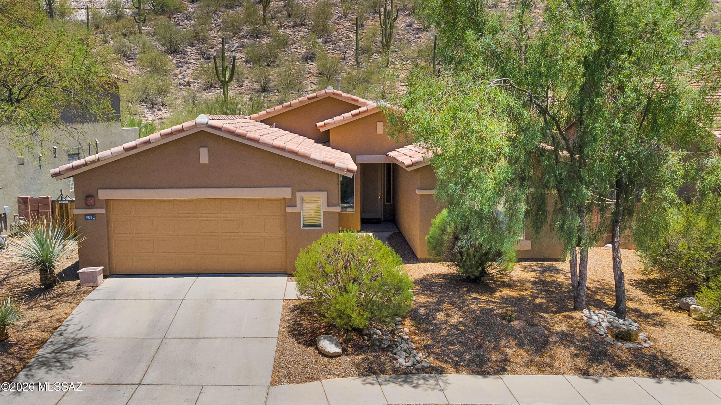 Welcome to the highly desirable gated community of Sabino Mountain! This well maintained 3-bedroom plus den, 2.5-bath home is move in ready. The open floor plan features high ceilings and a wall of windows in the great room, which brings natural light in. A highly desirable split bedroom design provides privacy and comfort, making it ideal for both everyday living and entertaining. Significant updates include newer roof underlayment (2022), HVAC (2022), exterior paint (2026), and carpet (2026).  Step outside to enjoy a private, low-maintenance backyard with picturesque saguaro views.  Explore all this location has to offer, a community pool and clubhouse, close to Sabino Canyon, hiking trails, dining, and shopping!