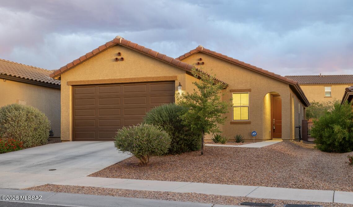 MOVE IN READY home in the gated community of Rocking K!  Many upgrades include granite counter tops, large kitchen island, white cabinets throughout, 20 inch tile flooring, and modern light fixtures. Built in 2021, this energy-efficient home features an open floor plan where the kitchen opens directly to the great room and dining area. Split bedrooms for primary privacy. Backyard with view fencing that backs up to common area. Short distance to the community splash pad, playground, courts, playing fields, and Saguaro Creek K-8.