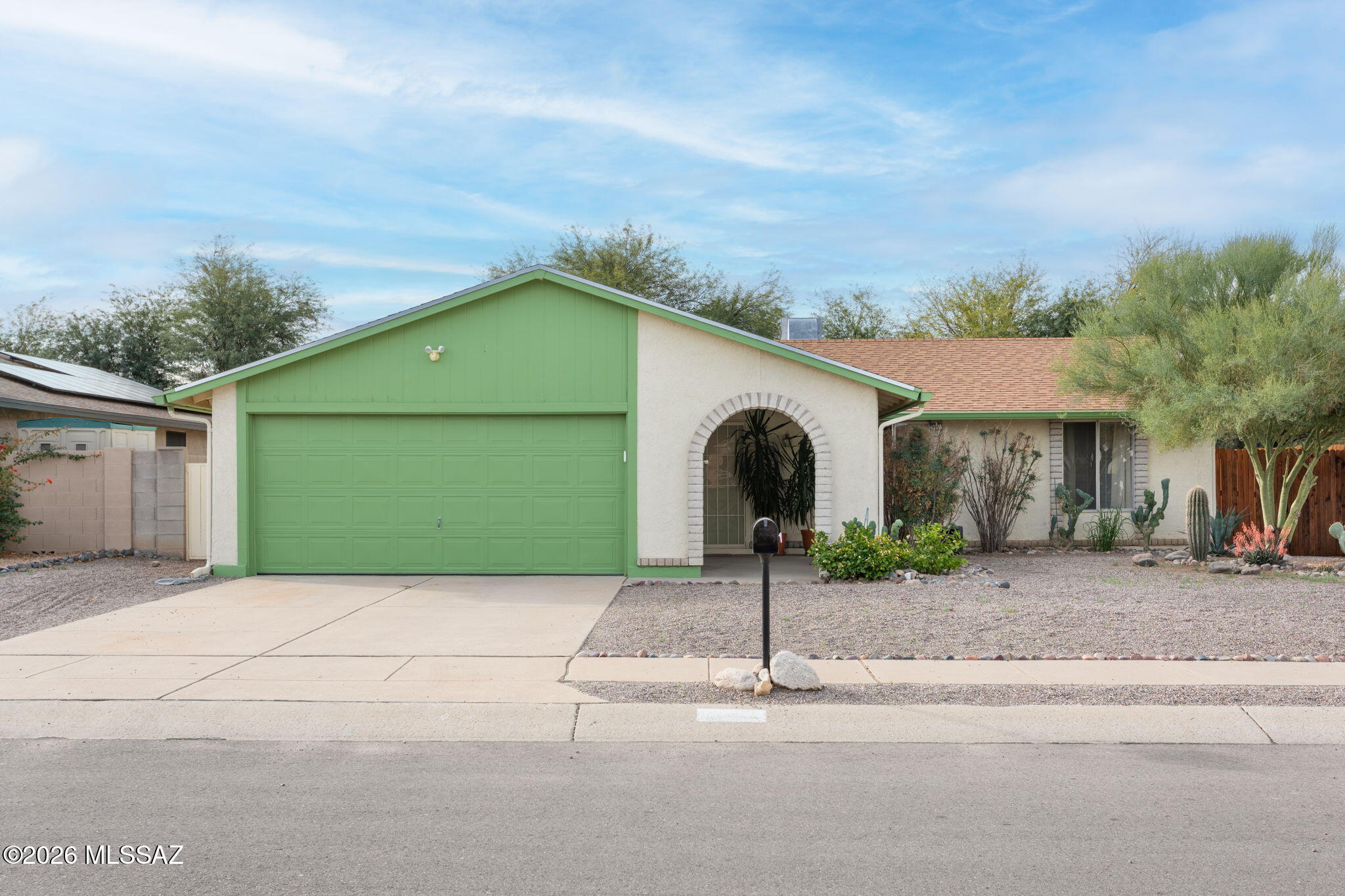 Charming 3BD/2BA (1,248 sq ft) home offers peeks of the Catalinas and NO HOA! Covered porch flows to an open, inviting floor plan with distinct living & dining areas. Chef's kitchen hosts sleek white appliances, ample cabinets/counter space, double door pantry w/ built-in shelves plus outer breakfast area. Enjoy beautiful Saltillo tile in main living areas with plush carpeted bedrooms. Primary suite features ensuite bath with tiled shower and a walk-in closet. Two guest rooms access full hall bath. Extended rear covered patio  overlooks an expansive, easy care yard. 2-car extended garage houses laundry, built-in storage shelves & brand new water heater. Additional updates include heat pump (2019), washer & exterior paint (2021). Within close proximity to schools, shopping, dining and I-10.
