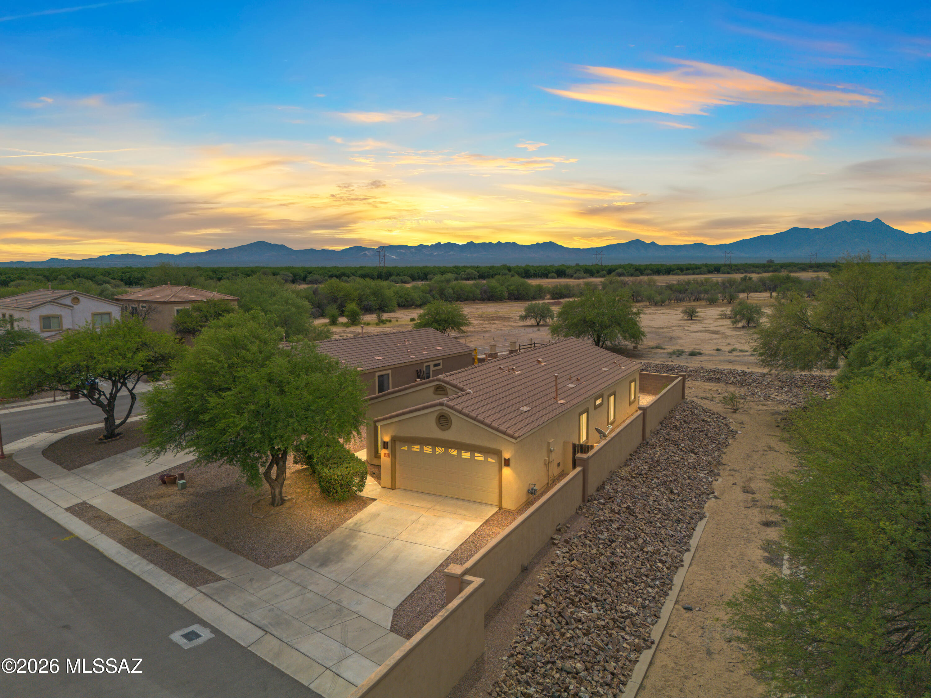 Discover this beautiful single-story 3 bedroom 2 bath home in  Presidio de las Estrellas subdivision, offering comfort, style, and privacy. With no rear neighbors and stunning Mountain View's, this property provides a peaceful retreat while still being close to everything you need.
Inside, you'll find a spacious family room that flows seamlessly into the kitchen, featuring granite countertops, stainless steel appliances, and a convenient kitchen eating area perfect for both everyday living and entertaining. The home also includes a laundry room with a closet and utility sink for added functionality. The primary suite offers a walk-in shower and single-sink vanity and a walk in closet with extra storage space. The hallway bath with a shower/tub combo serves the additional two bedrooms. Step outside to enjoy the covered patio, ideal for relaxing while taking in the scenic surroundings.  Enjoy access to the many amenities of Rancho Sahuarita and its convenience to close shopping, dining, and everyday essentials.