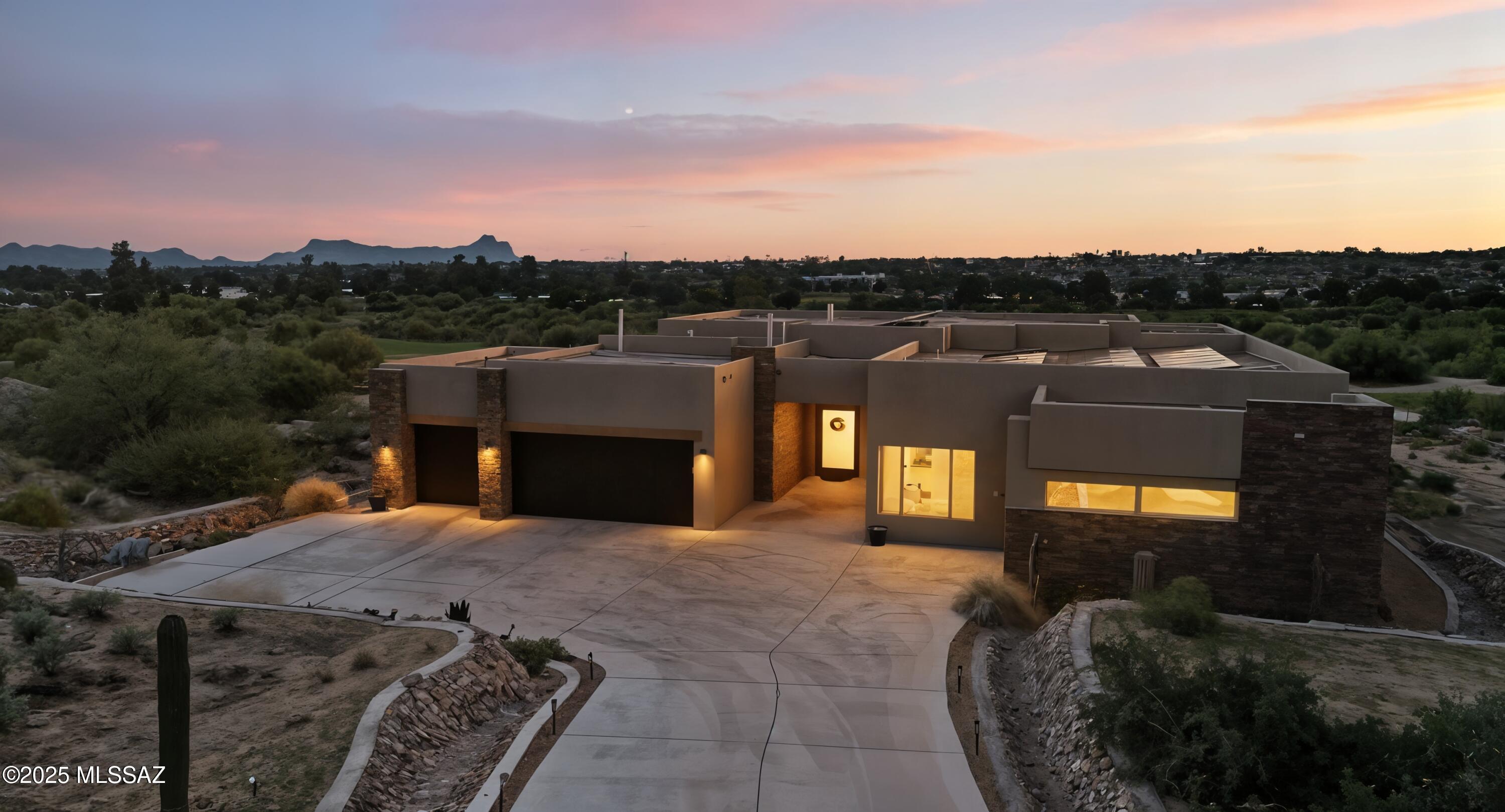 This exceptional, former Fairfield model home blends elevated design with resort-style living, set on 1.3 acres overlooking the pristine Sonoran Course at the prestigious Omni Tucson National. With 3,770 square feet of refined livability, the residence offers soaring ceilings and an abundance of natural light, creating a dramatic yet welcoming ambiance. Thoughtfully curated designer finishes are showcased throughout, highlighted by an oversized chef's kitchen with custom cabinetry, professional-grade appliances, and a sleek Distinction Series linear fireplace anchoring the great room. Four bedrooms, each with its own en-suite and walk-in closet, ensure privacy and comfort, complemented by an additional powder room. A dedicated home office and a versatile teen lounge provide ideal spaces for both work and play. Expansive 16' x 10' retractable glass doors dissolve the boundary between indoor comfort and outdoor luxury. Step outside to a resort-inspired backyard complete with a fully equipped outdoor kitchen, dramatic fire feature framing the pool, and sweeping fairway and mountain vistas. Every detail has been elevated with premium materials, sophisticated upgrades, and a cohesive design palette. Refined, luxurious, and crafted for a life of effortless elegance-this is desert living at its finest.