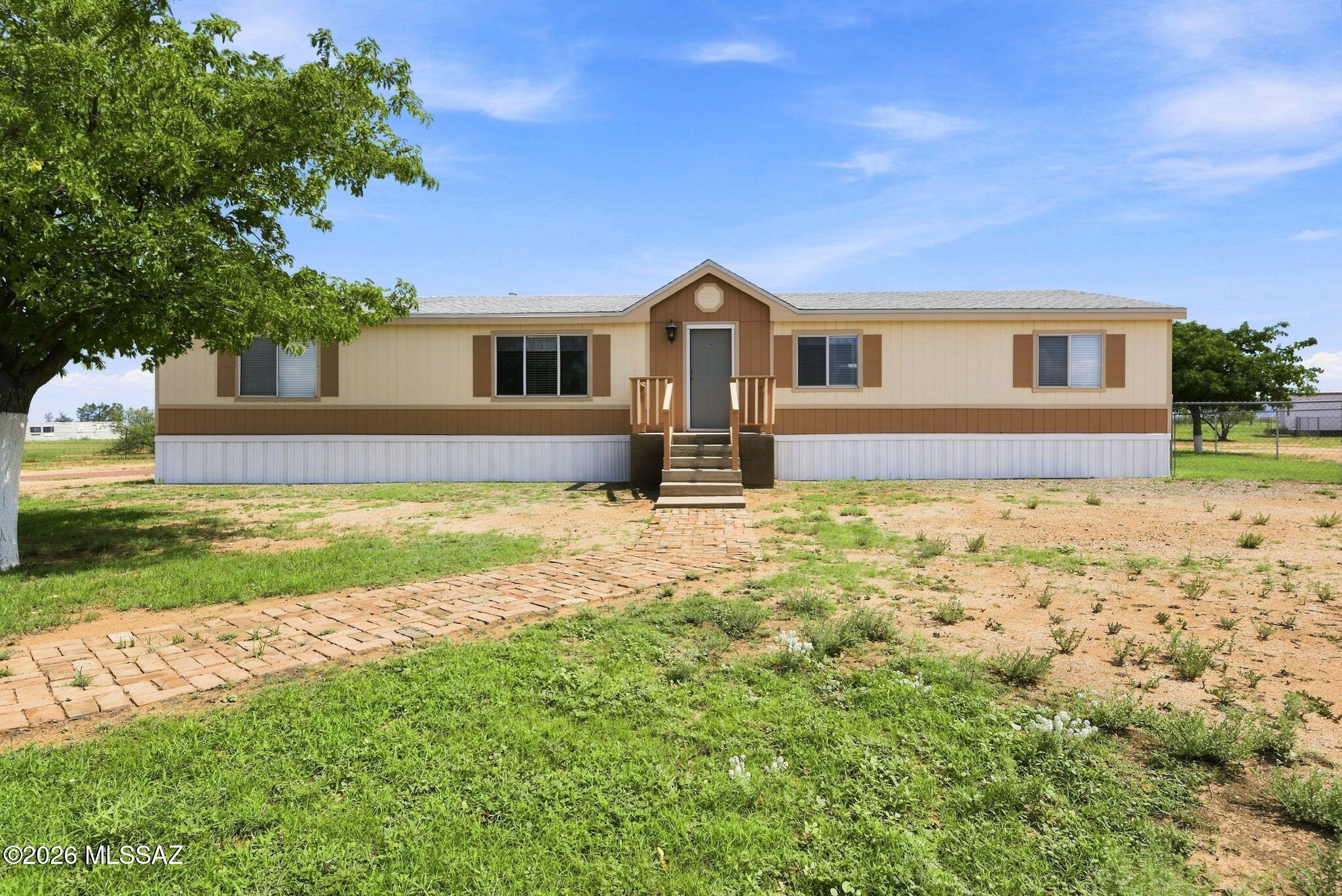 Welcome to your own slice of Arizona ranch country! Beautifully set up for horses and rural living, this exceptional property offers 2.26 acres providing space, infrastructure, and flexibility to bring your equestrian or small-ranch dreams to life. The updated 1,792 sq ft, 4-bedroom, 2-bath home offers comfortable living with a covered rear deck creating an inviting spot to relax and enjoy the wide-open surroundings. NEED more room to roam? The adjoining 6.78 acres may be available separately and features a 712 sq ft, 2-bed, 1-bath mobile home, four-stall horse barn, tack room, two-story hay barn, pole barn, detached garage, large carport, RV storage, and full fencing and cross-fencing. Tractor with implements available for separate purchase. Whether you're looking for a peaceful rural retreat or a place to build your own small ranch, this property offers acreage and opportunity in beautiful Cochise, Arizona. Come see the possibilities and make it your own.