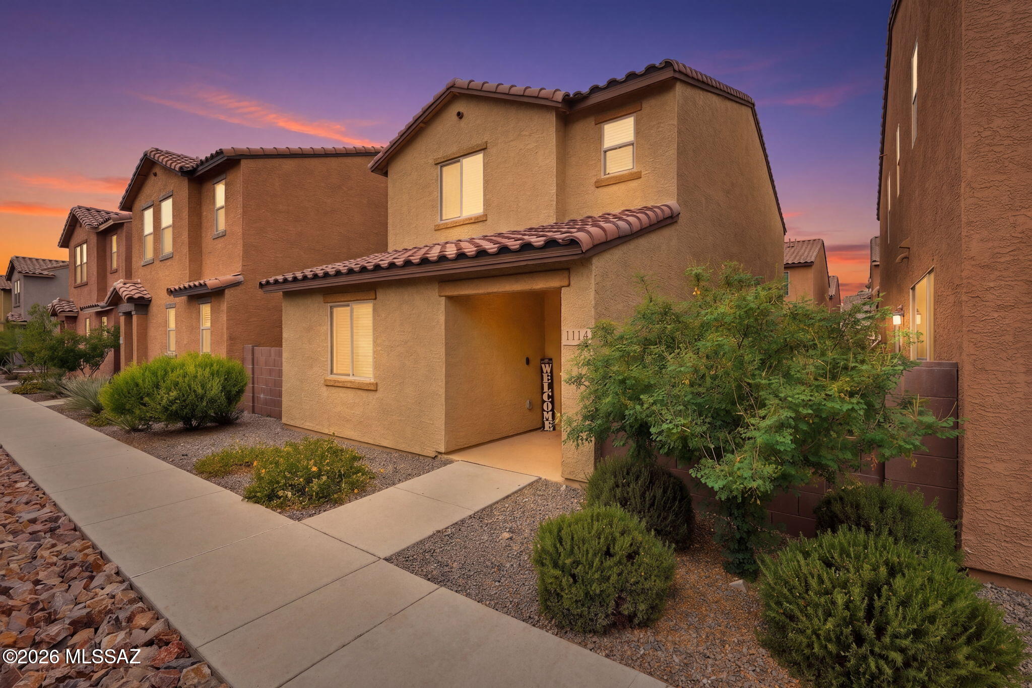 Amazing opportunity for turnkey 3 bed/2.5 bathrooms 1,442 SqFt, energy efficient 2022 built modern home with attached 2 car finished garage w/epoxy concrete floor on low maintenance R2 lot located in desirable Mountain View neighborhood in thriving Central Tucson. Featuring Catalina mountain views, concrete tile roof, S/N orientation provide amazing sunsets, sewer clean outs, ample guest parking  and concrete community sidewalks. Inside buyers will appreciate Energy Star qualified energy efficient double pane windows and slider throughout, painted textured ceilings (no popcorn), custom white wood window blinds and curtains, Ring security camera door bell, dual Ecobee Smart digital thermostats, recessed lighting, LED lighting, 18'' tile and plush carpet in bedrooms, downstairs bathroom, crisp white two panel wood internal doors, illuminated ceiling fans,  upstairs internal laundry room with white washer & dryer included. 
Entertainer's dream open concept kitchen with faux full slab granite countertops, w/bar seating, modern kitchen cabinets, gas stove, stainless steel appliance package, kitchen peninsula w/bar seating, walk-in pantry closet, stainless steel appliance package including side-by-side fridge with ice/water dispenser, built-in microwave, gas stove, dishwasher, dual metal undermount sinks, garbage disposal, garden window, dining area adjacent to spacious great room with abundant natural light and energy efficient slider leading to covered patio and low care backyard with artificial turf and upgraded Belgard pavers surrounded by concrete block privacy walls. Generous carpeted bedrooms with flat screen TV wall mounts, full guest bathroom w/executive height modern vanity, exhaust fan, shower and tub. Spacious primary suite with ensuite full bathroom, matching executive height modern cultured marble dual sink vanity, walk-in tiled shower and sizable closet. 

Affordable $43 monthly HOA allows rentals. Fantastic Central Tucson location with a 95 Biker's Paradise score, walking distance to Guadalajara Original Grill and minutes to groceries, restaurants and shopping.
Close proximity to Chuck Huckelberry Loop/ Rillito River Path (136 mile multi-use connected paved path used for walking, running, biking and skating), Rillito River Wash, Trader Joes and St Phillips Plaza, Banner Medical Center and the University of Arizona campus! Call to make your appointment to view this move-in ready modern home today!