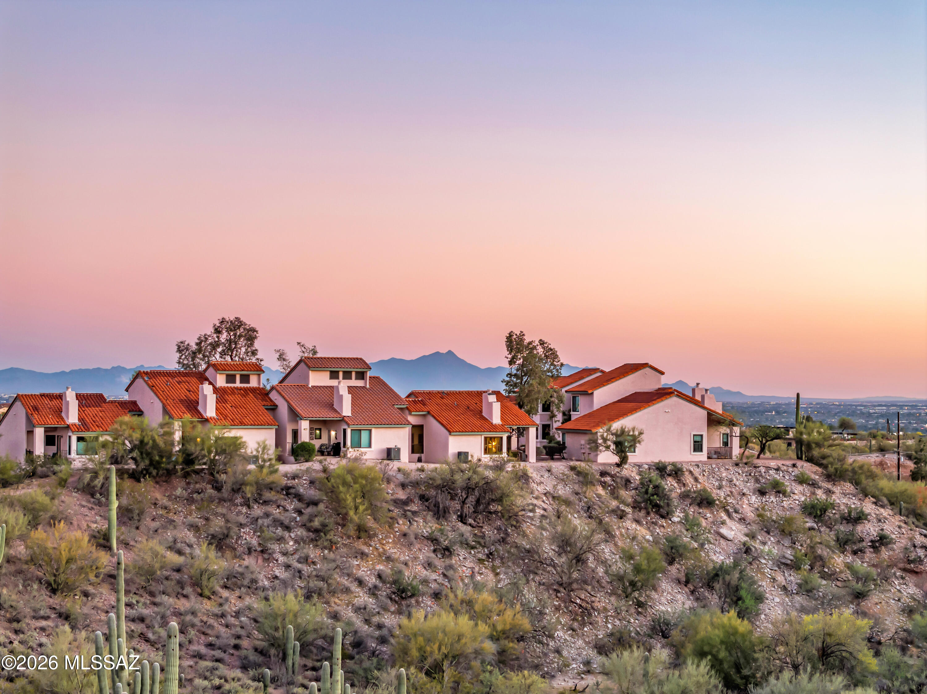Rare opportunity to own a piece of this private ''island in the sky.'' This meticulously curated desert retreat is designed as the perfect cabin escape, offering panoramic Catalina Mountain views from a premium lot adjacent to a natural wash. With only one shared wall, enjoy added privacy and tranquility. Inside, the home features solid wood custom cabinetry and warm, inviting finishes throughout. The community offers a private pool, tennis courts, and exclusive trail access to nearby open space--ideal for enjoying Tucson's outdoor lifestyle. A perfect lock-and-leave option for seasonal living or a peaceful full-time retreat.