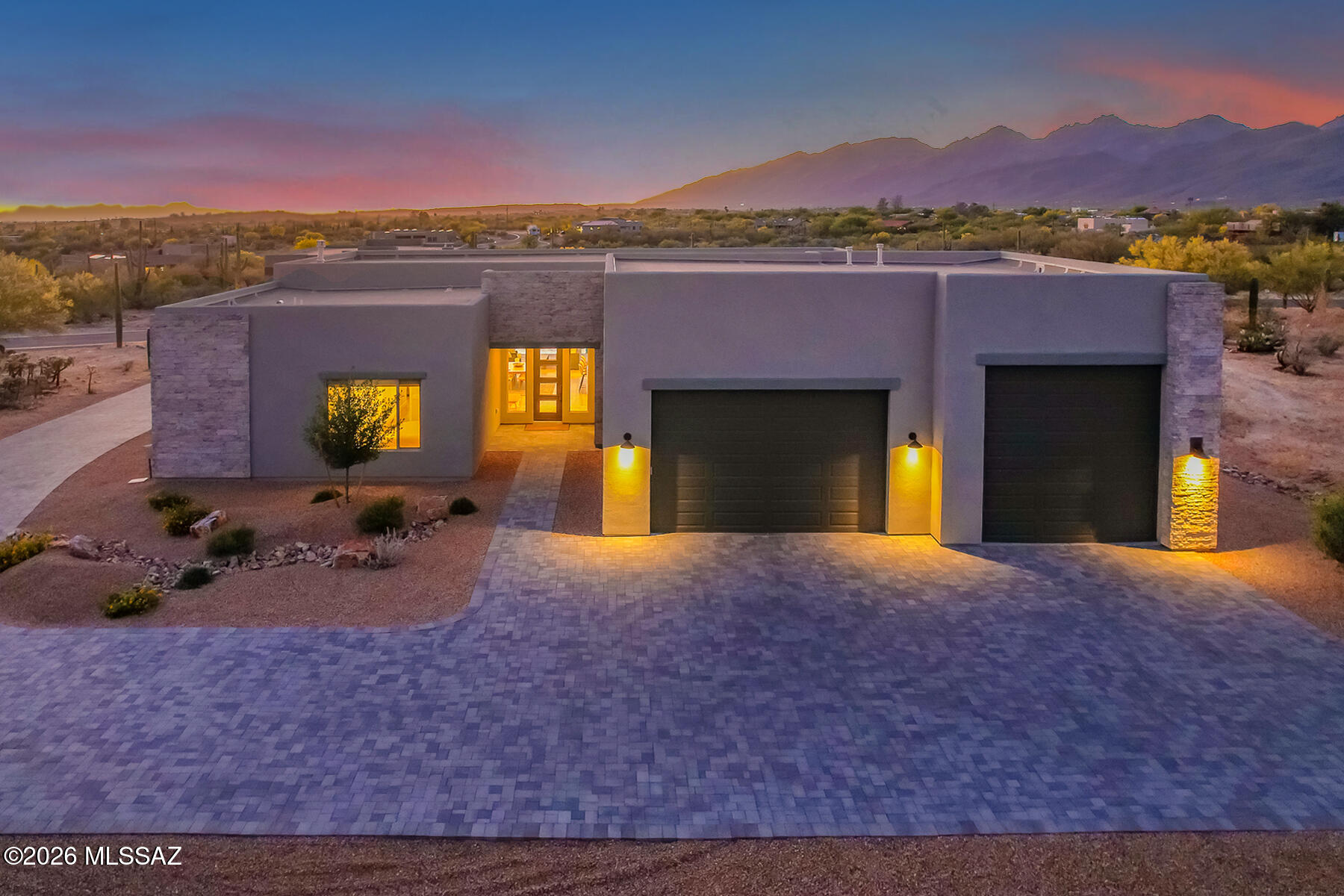 Set on almost a full acre in gated Rancho Soldados, this Fairfield Homes residence pairs contemporary desert design with a setting that fully embraces the beauty of Northeast Tucson. Completed in late July 2025 and lightly lived in for just 6 months, the home presents as essentially brand new. Spanning 3,043 square feet, the single level floor plan offers 3 en suite bedrooms, a den, 3.5 baths, and a 3 car garage with an oversized RV bay.

Designed for true indoor/outdoor living, the home is centered around expansive open living spaces and large sliding glass doors that open fully to the covered patio and backyard, creating a seamless connection between inside and out. Interior finishes are clean, warm, and refined, with porcelain plank wood-look flooring, soaring ceilings, shaker style cabinetry, quartz countertops, premium LG stainless steel appliances, a waterfall island, an additional bar area, and a butler's pantry with coffee bar. The great room fireplace adds architectural presence, while the spacious primary suite features a custom walk in closet and a beautifully finished bath with double vanity and oversized walk-in shower. Outside, the Garden Gate designed backyard is the true showpiece of the property, with pool, spa, generous patio space, and striking mountain views that make the setting feel both peaceful and dramatic. Private, polished, and nearly new, this is a standout offering in Rancho Soldados.
