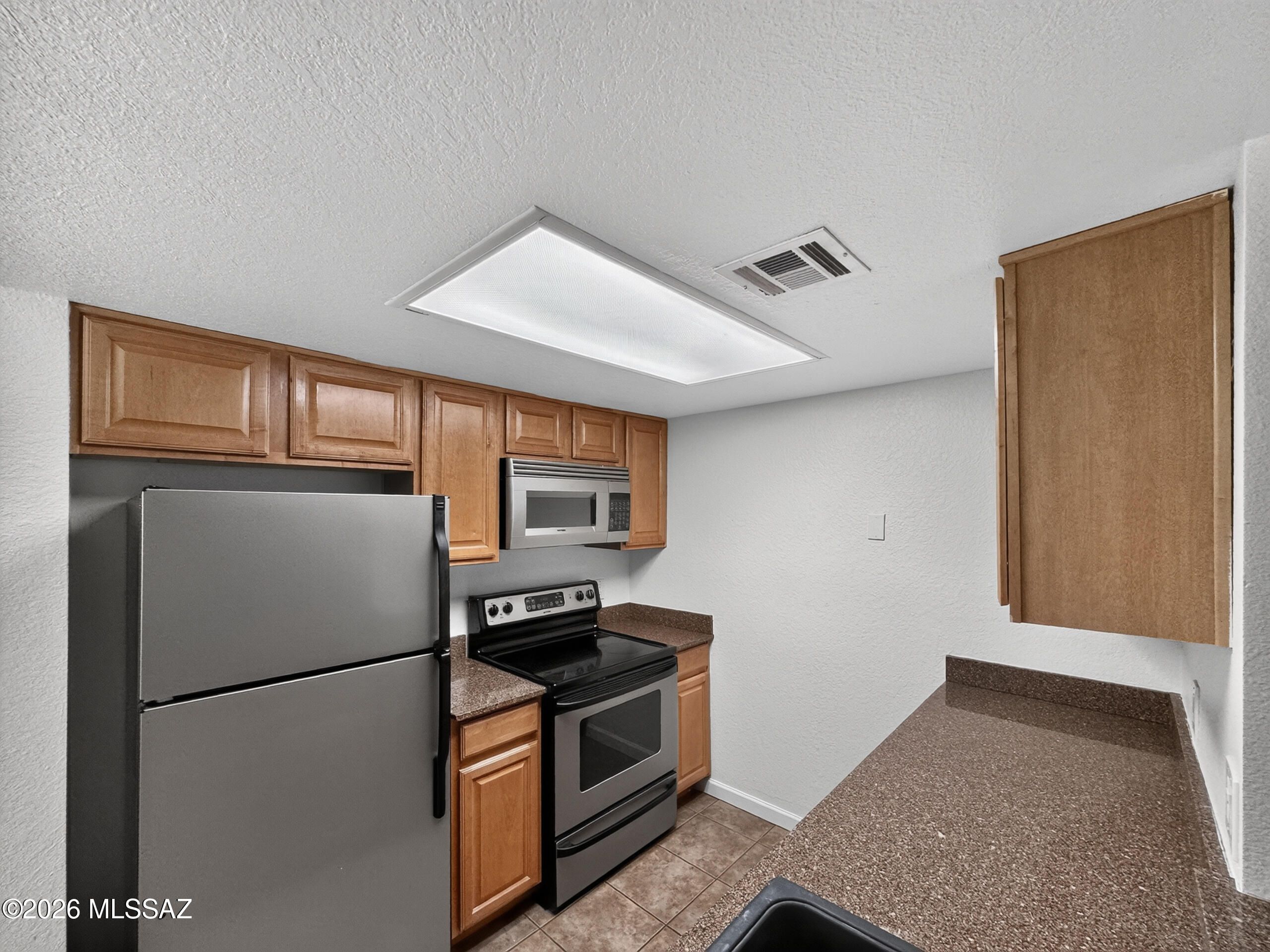 Pleasantly situated toward the back of the community, this cozy 3-bedroom condo offers a peaceful setting with a private patio overlooking the natural desert landscape. Conveniently located on the first floor, the home provides easy access and a comfortable indoor-outdoor lifestyle. Enjoy nearby hiking and walking trails, along with the amenities of the neighboring resort. Ownership includes access to the resort and special discounts on golf, dining, spa services, and more. A wonderful opportunity to enjoy the beauty and relaxed lifestyle of the Tucson desert. Owner/Agent