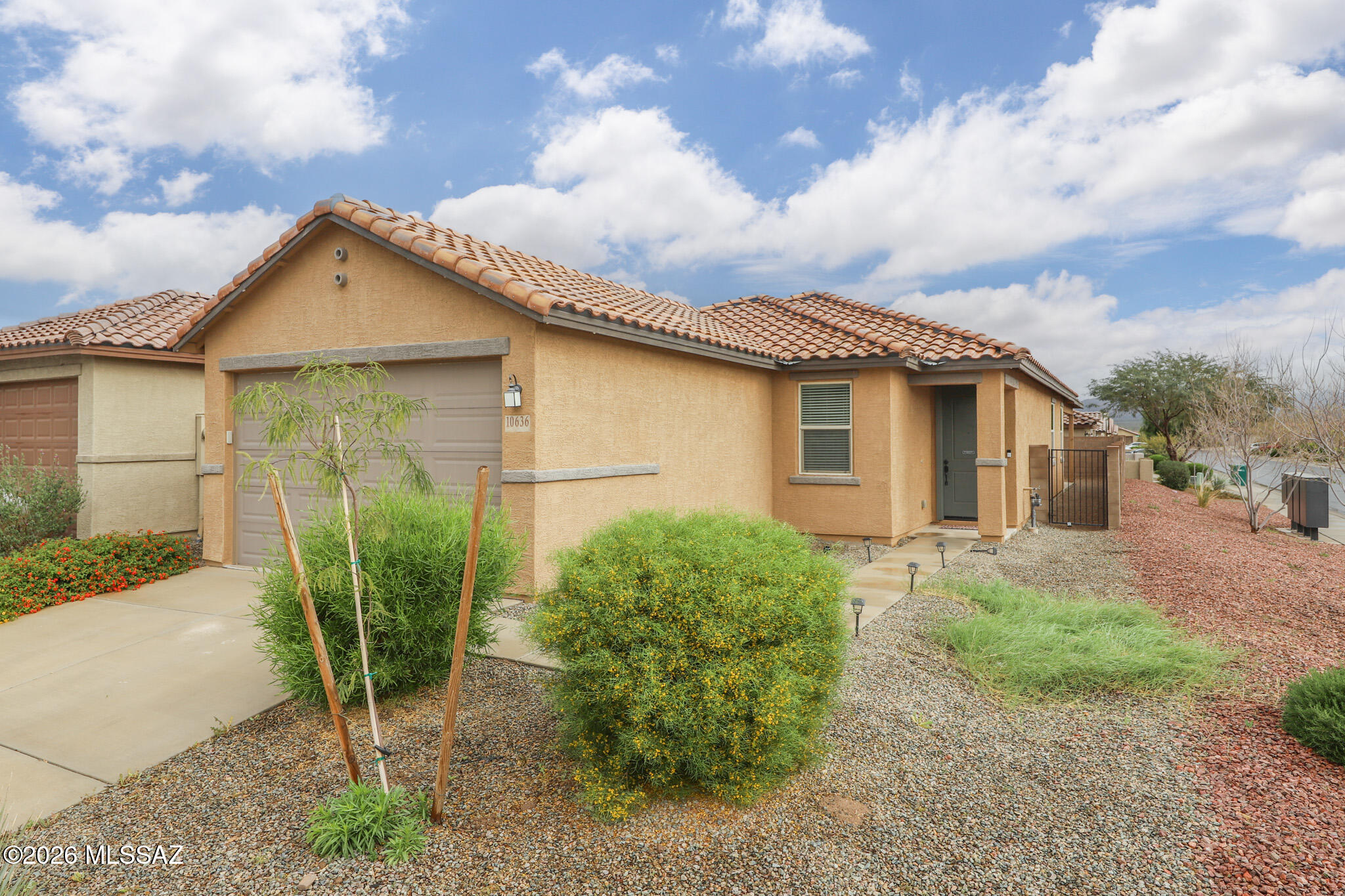 Discover this beautifully maintained single-story home in the sought-after Gladden Farms community in Marana. Built in 2022 and offering 1,745 square feet, this thoughtfully designed residence combines modern style with everyday comfort.
Inside, the home features a bright and open living space where the kitchen, dining, and living areas connect seamlessly, creating an ideal setting for both daily living and entertaining. A versatile flex room with French doors provides the perfect spot for a home office, study, or additional lounge space.
The primary suite offers a private retreat with a spacious layout, elegant bathroom design, and a generous walk-in closet. The additional bedrooms are well positioned to provide comfort and privacy for family members or guests. Step outside to a low-maintenance backyard with a covered patio, offering a relaxing outdoor space that's easy to care for and perfect for enjoying Arizona evenings.
Located in the Gladden Farms master-planned community, residents enjoy access to numerous neighborhood parks, playgrounds, walking paths, and dog parks that create a welcoming and active environment. With convenient access to nearby shopping, dining, and major roadways, this home offers both comfort and convenience in one of Marana's most popular communities.
Move-in ready and beautifully kept, this home is an excellent opportunity to enjoy modern living in Gladden Farms.