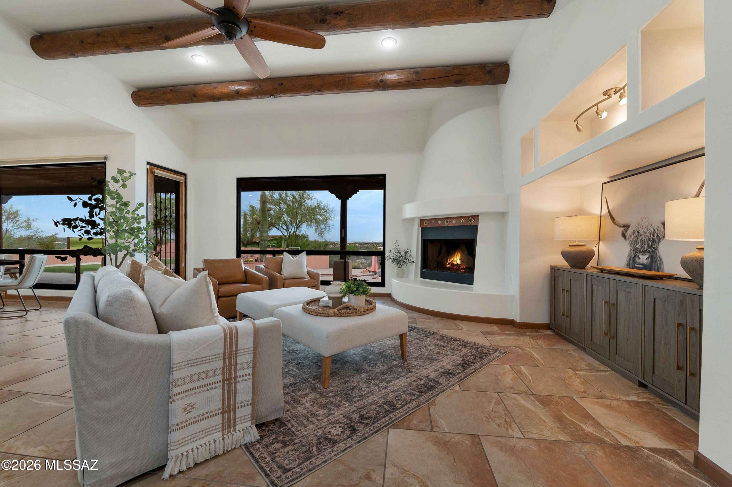 Welcome to an elevated desert retreat, where sweeping mountain views, privacy, and effortless entertaining come together across 3.59 acres. Perched on a hilltop, this 2,889 square foot home features a thoughtfully designed split bedroom floor plan with 4 spacious bedrooms, a den/flex space and 3 full baths. A charming gated courtyard creates a beautiful first impression, while fresh interior paint provides a crisp, refreshed backdrop throughout the home. The generous primary suite offers direct access to the patio, inviting you to step outside and take in the surrounding beauty at any moment. At the heart of the home, the open concept kitchen impresses with a large center island with breakfast bar, perfect for casual gatherings, and flows easily into the living spaces for more formal occasions. Every window seems to frame the surrounding desert beauty. The outdoor living experience is truly exceptional. A sparkling pool and spa are perfectly positioned to capture the extraordinary mountain vistas, creating a private setting for relaxing, entertaining, and enjoying Arizona sunsets. An expansive covered patio, lush turf, built-in fire pit with seating, and an official horseshoe pit make the grounds as functional as they are inviting.

Adding even more versatility is the detached Art Haus--an inspiring flex space with endless possibilities. Whether envisioned as a creative studio, private workspace, exercise room, hobby retreat, or additional storage, it offers the freedom to make the space uniquely your own. Rainwater harvesting barrels further complement the property's thoughtful desert lifestyle.

And the location is hard to beat. With no HOA, ample acreage, and convenient access to everyday amenities, this private haven also places you near the natural beauty of Mount Lemmon and Saguaro National Park East. A rare opportunity to enjoy expansive space, breathtaking views, resort-style amenities, and the freedom of acreage--all in one remarkable property.