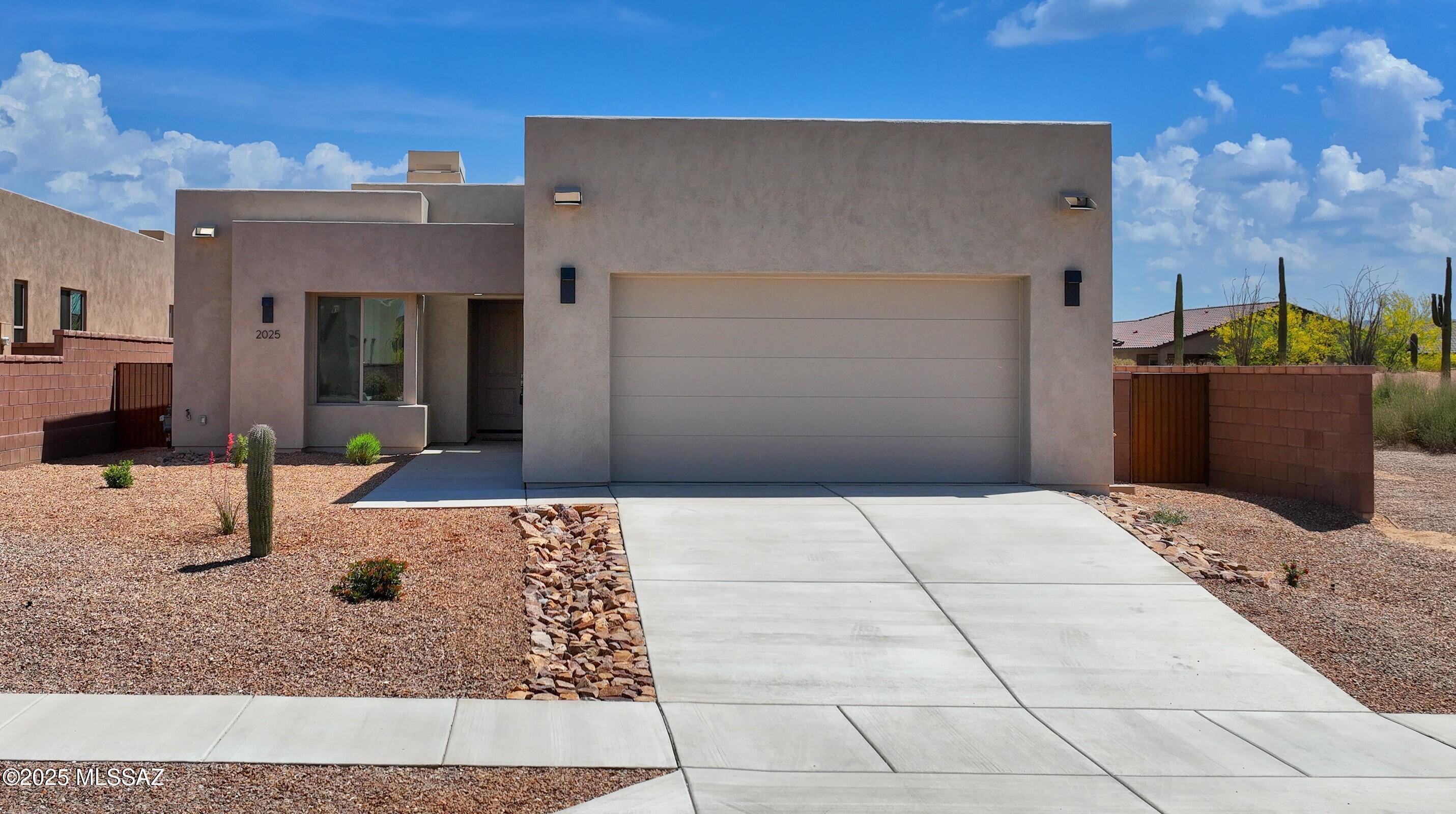 Come be a part of this absolutely stunning brand new gated community with luxurious homes designed by renowned architect, Ron Robinette and boasting a spectacular location just north of Magee and La Cholla.  Features in this gorgeous contemporary home include fabulous greatroom with very cool floating drop ceiling, lovely tiled fireplace, huge gourmet island kitchen, stainless steel appliances, granite counters, tons of cabinetry and designer tile floors.   Other amenities include spacious Primary Suite with generous walk-in closet, dual sinks and beautifully tiled walk in shower.  6-panel doors and beautiful lighting fixtures thruout.  Block walled in backyard w/exposed wood beam covered patio.  2-car garage.
