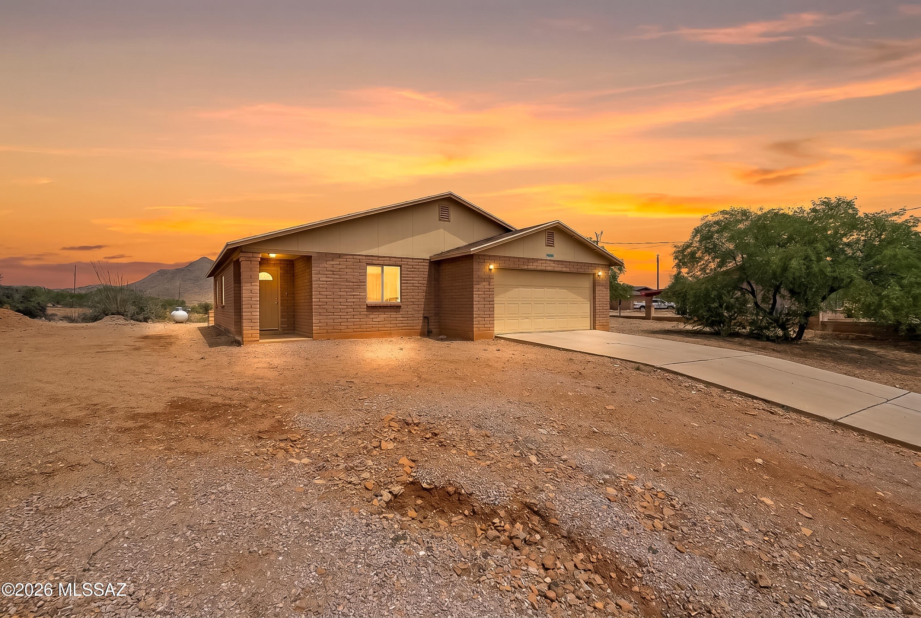 Experience Desert Beauty and Comfort in Rio Rico Ranchettes

Welcome home to this beautifully maintained 3 bedroom, 2 bath residence with a 2 car garage, where comfort, style, and breathtaking mountain views come together. From the moment you step inside, you'll appreciate the soaring vaulted ceilings, elegant tile flooring, abundant natural light, and spacious living and dining areas designed for both everyday living and entertaining.

The thoughtfully designed kitchen offers warm wood cabinetry, stainless steel appliances, a breakfast bar perfect for gathering, and direct patio access for seamless indoor outdoor living.

Retreat to generously sized bedrooms featuring laminate flooring and ample closet space, while the primary suite offers a peaceful place to unwind. Make your way outside and take in stunning Sierra Madre views and unforgettable Arizona sunsets from your backyard, creating the perfect setting for morning coffee or relaxing evenings.

Located in desirable Rio Rico Ranchettes, this move-in-ready home offers the lifestyle, views, and value today's buyers are searching for. Homes this well-cared-for and priced to attract attention do not last.

Schedule your private showing today before this exceptional opportunity is gone.