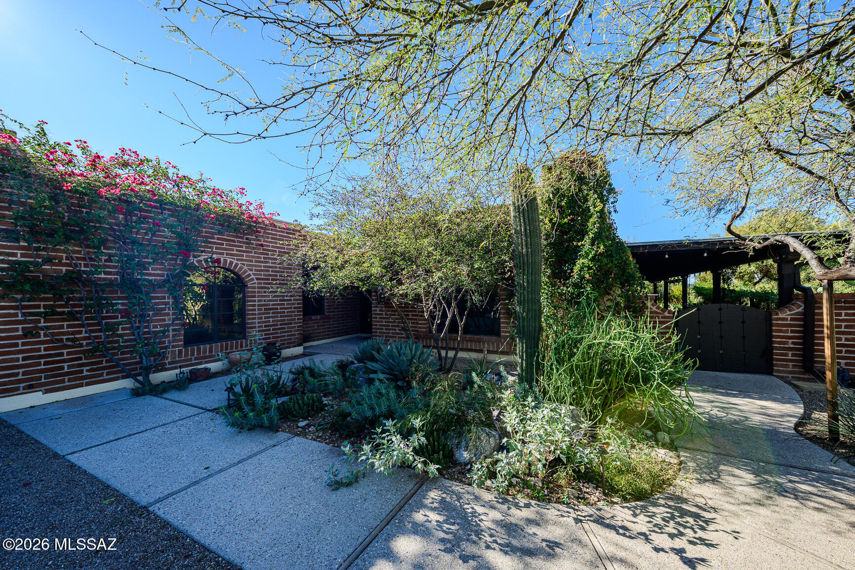 This 2,536 sq ft, 3BR, 2BA burnt adobe townhome sits on a beautiful .4-acre riparian cul-de-sac lot in popular Catalina Pueblo. Large living/dining area & family room w/10' beamed ceilings, skylights & multiple sliders open to wrap-around covered patios w/exceptional privacy including a fountain and low voltage lighting. Chef's kitchen w/48'' Sub-Zero, double ovens, Fisher & Paykel double dishwasher, RO, & bar seating. Large primary suite w/spa-like primary bath, multiple closets, concrete flooring throughout with travertine baths. Large bonus/media room is flex space off the primary bedroom. Attached 2-car garage w/storage. Updated plumbing & zoned HVAC. Three community pools & a spa with low HOA fees. Close proximity to La Encantada Mall & other shops, restaurants & galleries.