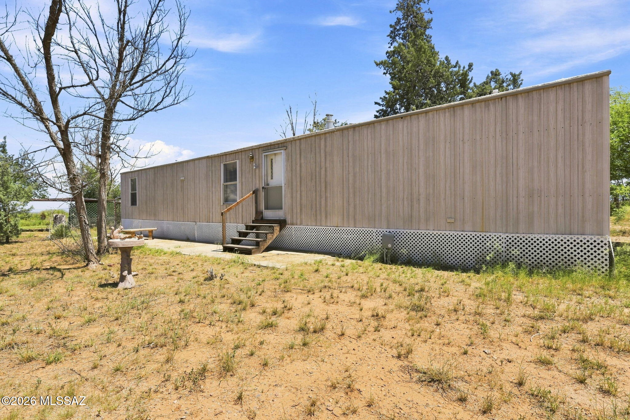 Welcome to this inviting 3-bedroom, 2-bathroom 2001 Clayton Spirit III manufactured home located in a small park in the Pearce/Sunsites area. The split-bedroom floor plan offers comfortable living with approximately 910 sq. ft. of space. Features include central A/C, forced-air heat, washer and dryer, refrigerator, electric range, microwave, water filtration system, and new PEX plumbing. Recent improvements include new skirting, with additional improvements throughout the home. The exterior offers a covered carport, storage shed, RV access, and a slab patio overlooking a pleasant yard with trees, grass, and desert landscaping. Lot rent is an affordable $180 per month and includes water, sewer, and trash. Conveniently located just off Hwy 191, close to the post office, library, shopping, restaurants, and other Sunsites amenities. A great opportunity for affordable living in southeastern Arizona. Park approval is required prior to purchase.