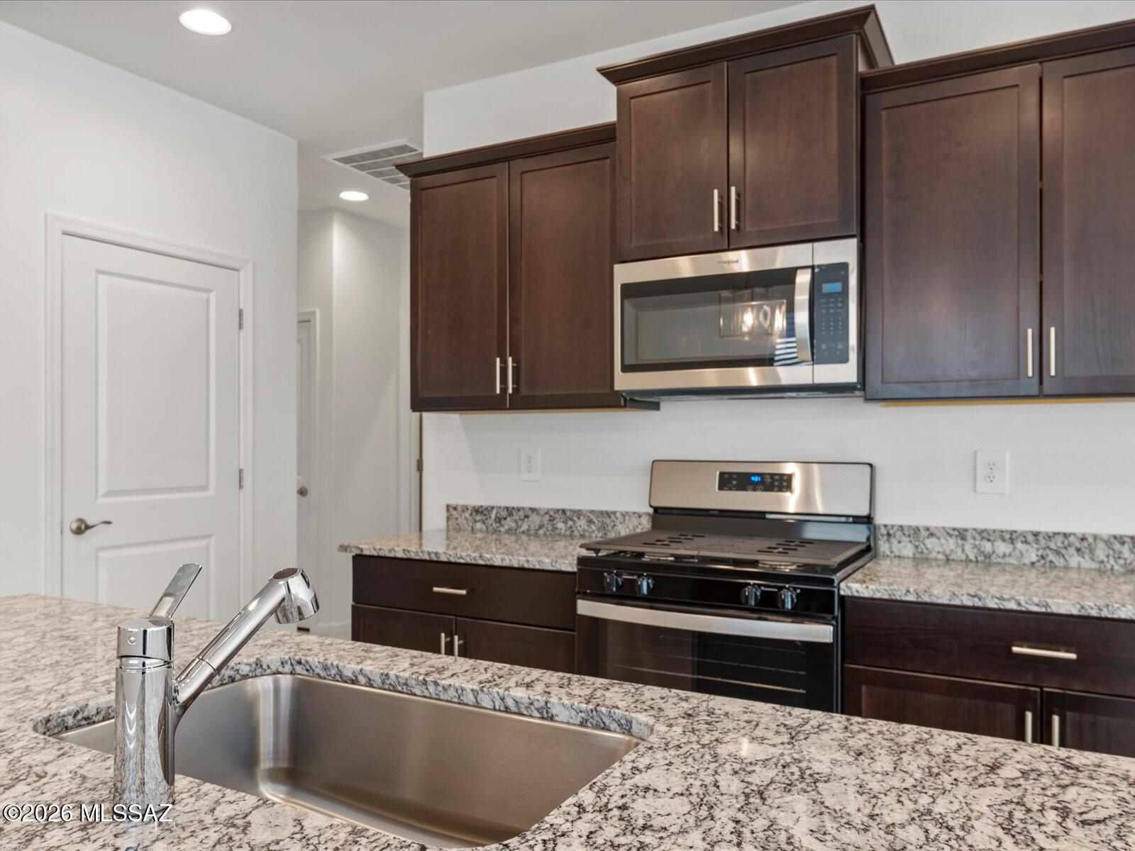 The Jasper floorplan offers 4 bedrooms and 2 bathrooms in a thoughtfully designed layout perfect for comfortable living. Rich umber cabinetry adds warmth to the kitchen, while the open great room flows seamlessly to a covered patio. The privately situated primary suite provides a peaceful retreat with added quiet and separation from secondary bedrooms. Las Patrias at Star Valley Phase III - Signature Series is now selling and located less than 10 minutes from I-10, offering easy access to employment centers and downtown Tucson. Community amenities include walking and biking trails and playgrounds. Move-in ready with washer, dryer, refrigerator, and whole-home blinds, plus innovative energy-efficient features designed to help you enjoy more and save more.